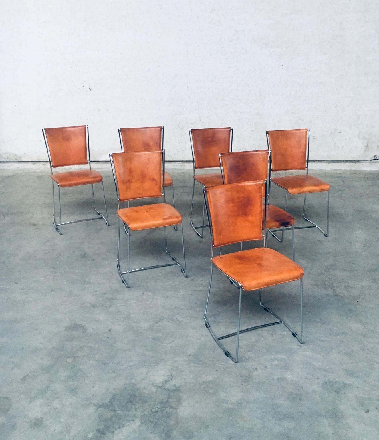 Vintage Postmodern Italian design natural leather dining chair set of 7 chairs by Segis, made in Italy in the early 1990's. Thick natural leather on chrome metal frame. Well patinated natural leather from it's age and use. Beautiful in their form