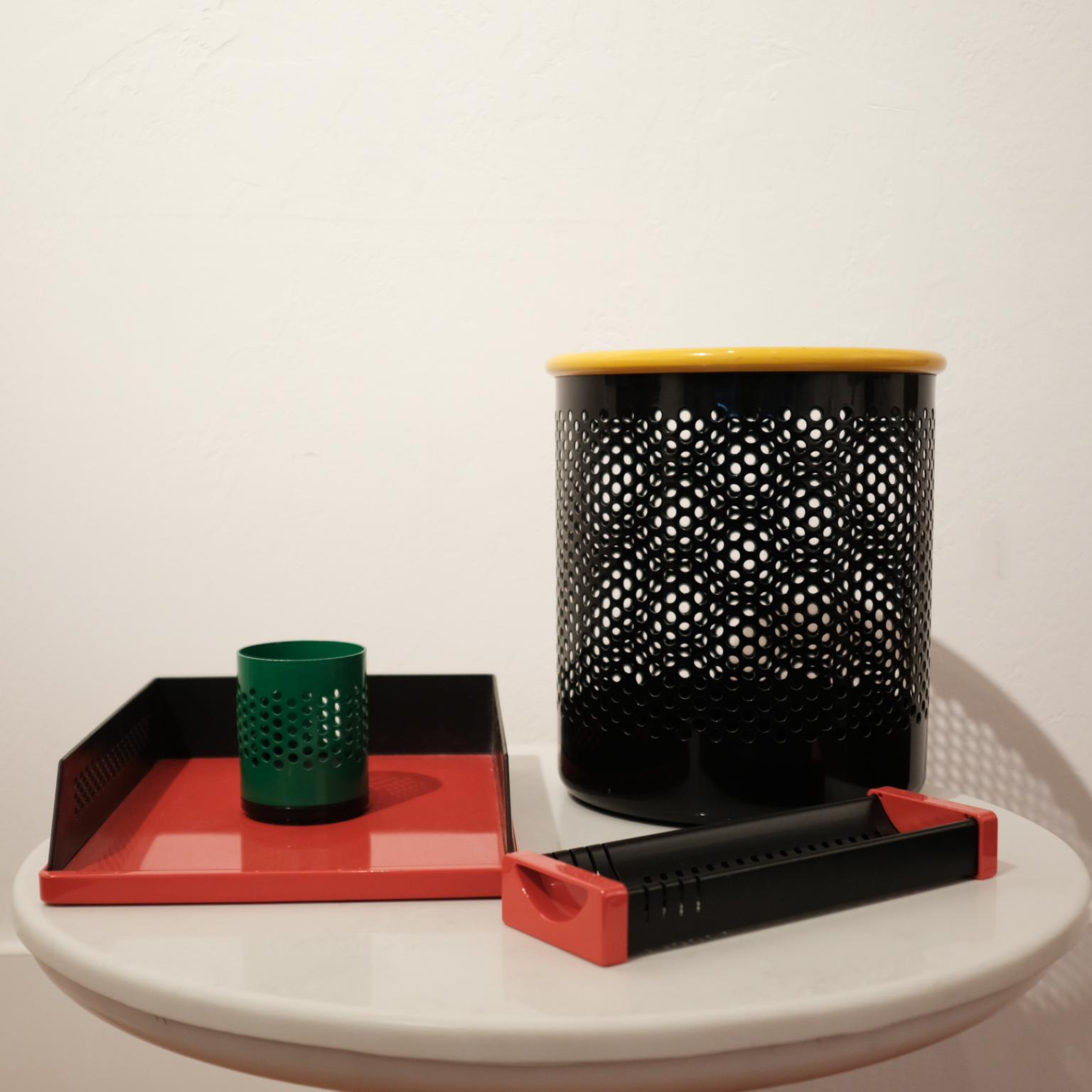 Postmodern Italian desk set, including a letter tray, pencil cup, catchall with card holder and a wastepaper basket. Perforated metal with plastic. Designed by Barbieri & Marianelli for Rexite, Italy, 1981.