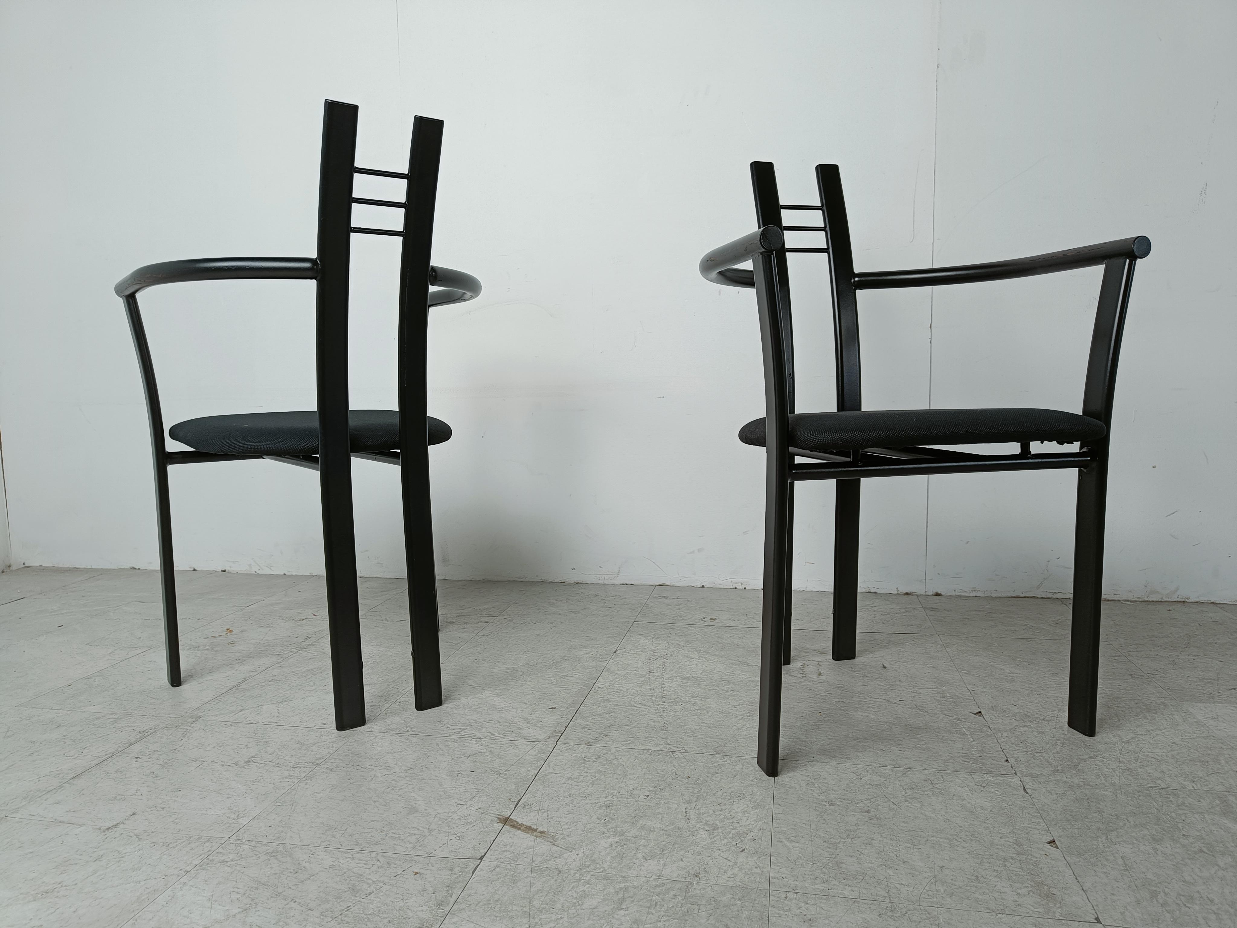 Set of 10 postmodern italian dining chairs with armrests.

Made out of black metal frames and black upholstered fabric seats.

Gorgeous timeless design.

Good condition

1980s - Italy

Dimensions:
Height: 90cm/35.43