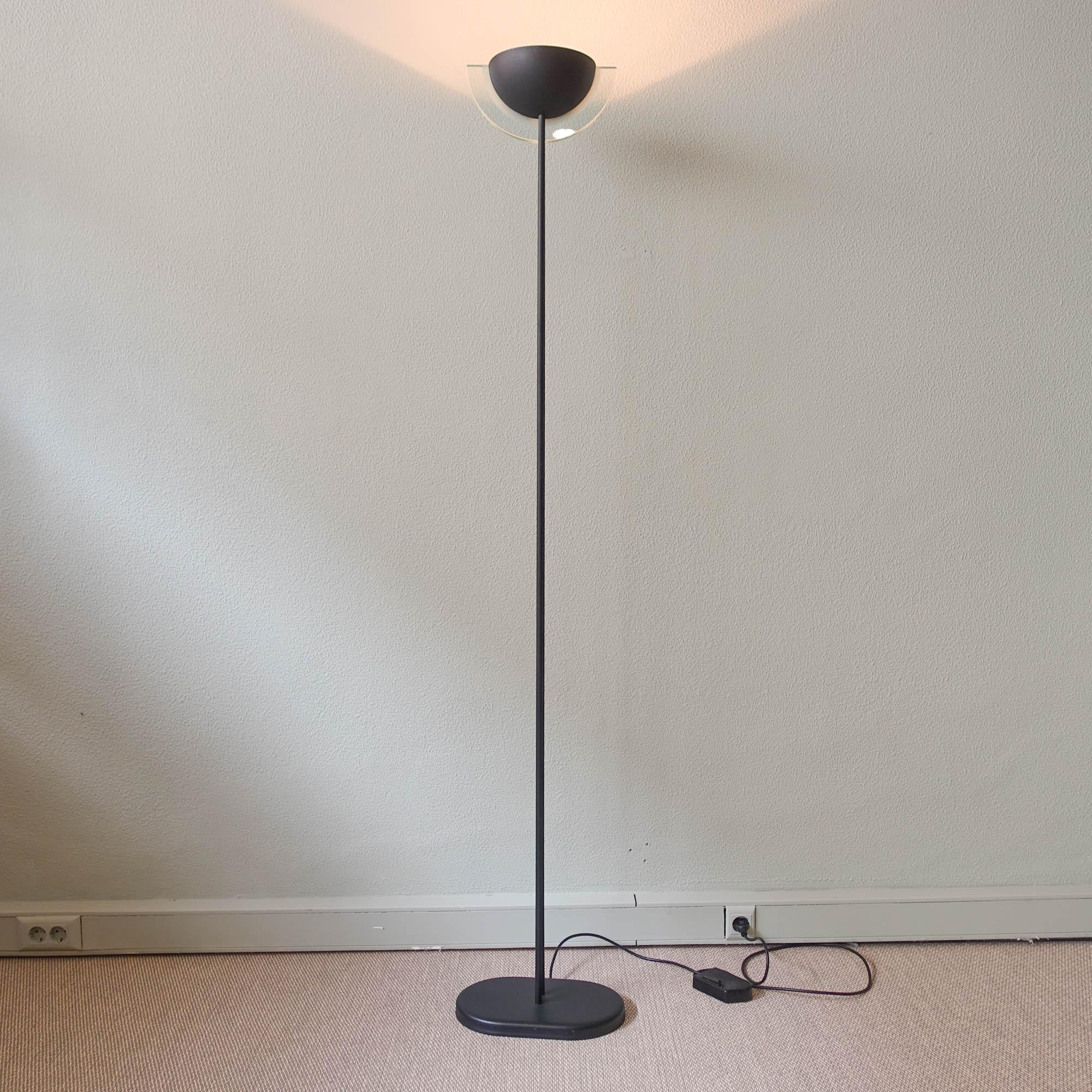 This floor lamp was designed and produced by Relco, in Italy during the 80's. It has a postmodern design typical for 1980s.
With black lacquered metal structure and shade, with glass incorporated that gives a diffuse light.
Lamp is in good vintage