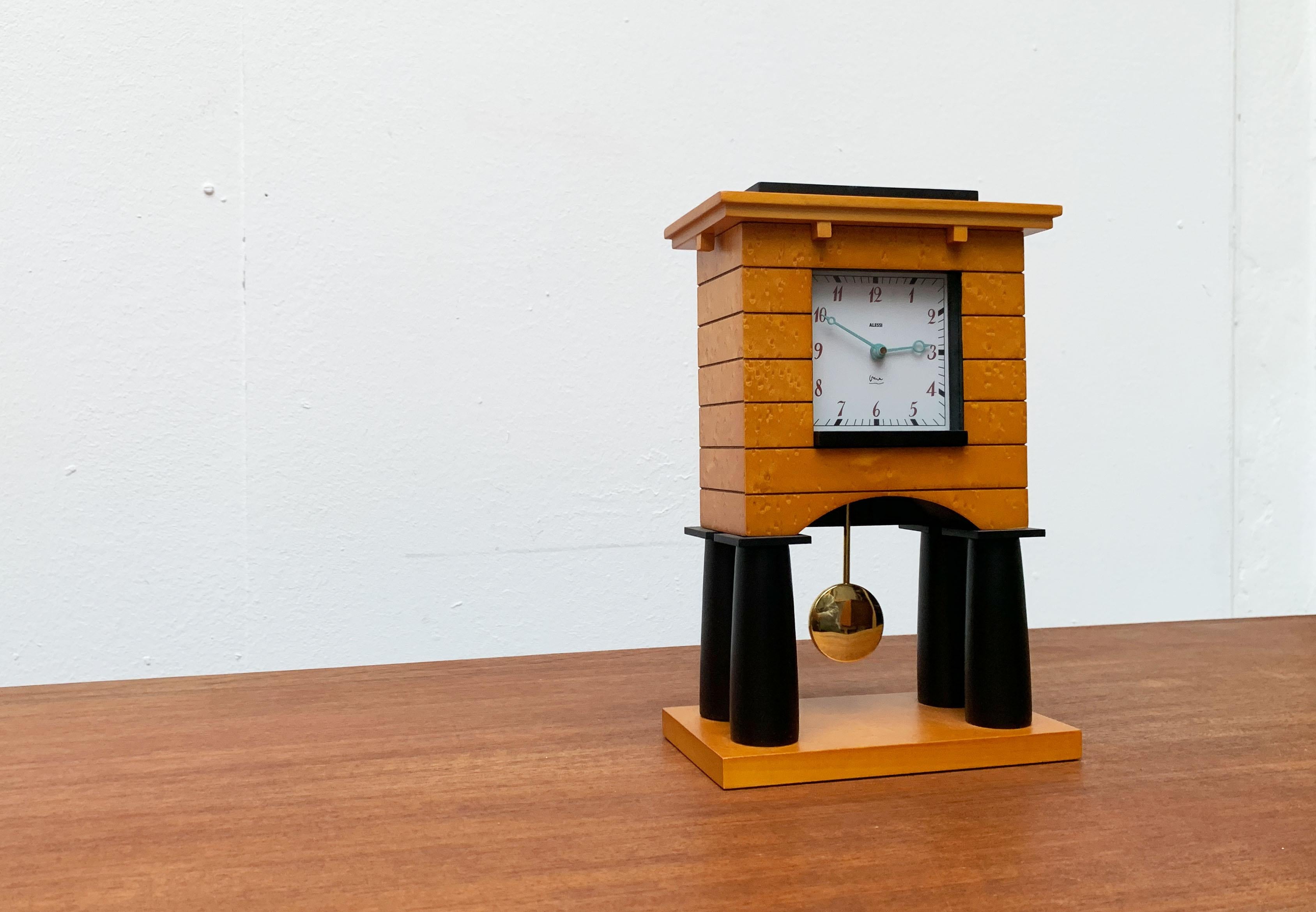 Rare table clock of the Italian manufacturer Alessi after a design by Michael Graves from 1986. A special and rare collector's object of Postmoderne.

The coat Clock is a miniature architecture. Graves combines constructive and decorative details of