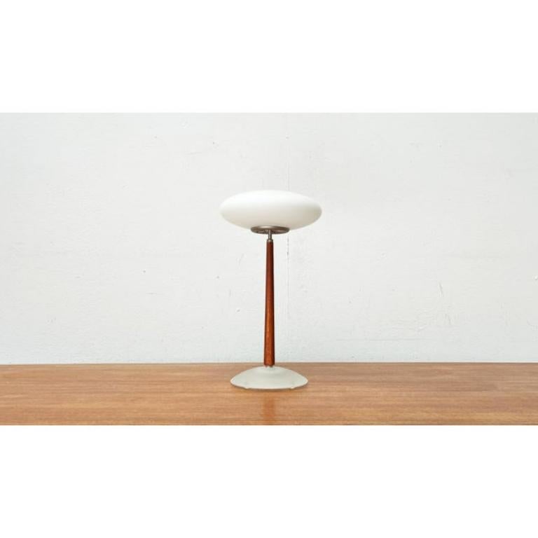 The small T1 table lamp version from the Pao lamp series by Matteo Thun.

The Pao lights impress with their characteristic diffuser made of frosted glass. What is particularly special, however, is the material combination of glass and wood that
