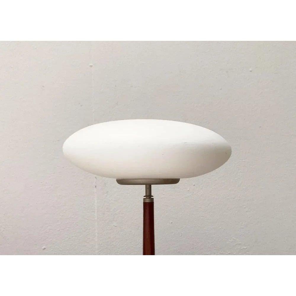 The small T1 table light version from the Pao light series by Matteo Thun.

The Pao lights impress with their characteristic diffuser made of matt glass. However, the material combination made of glass and wood is more special, which make these
