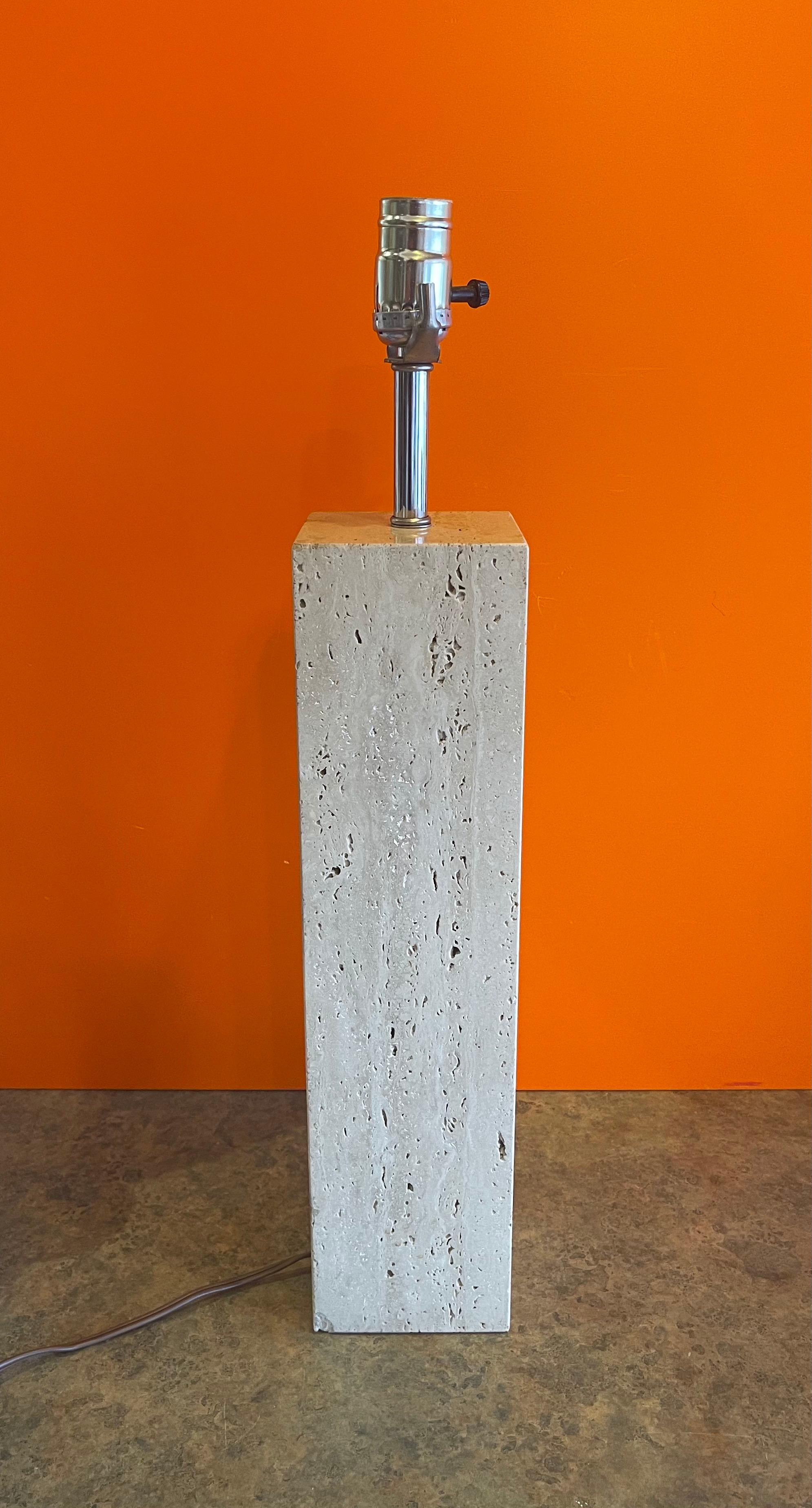Postmodern Italian solid travertine table lamp, circa 1980s. The lamp is in good vintage condition and the travertine base measures 4