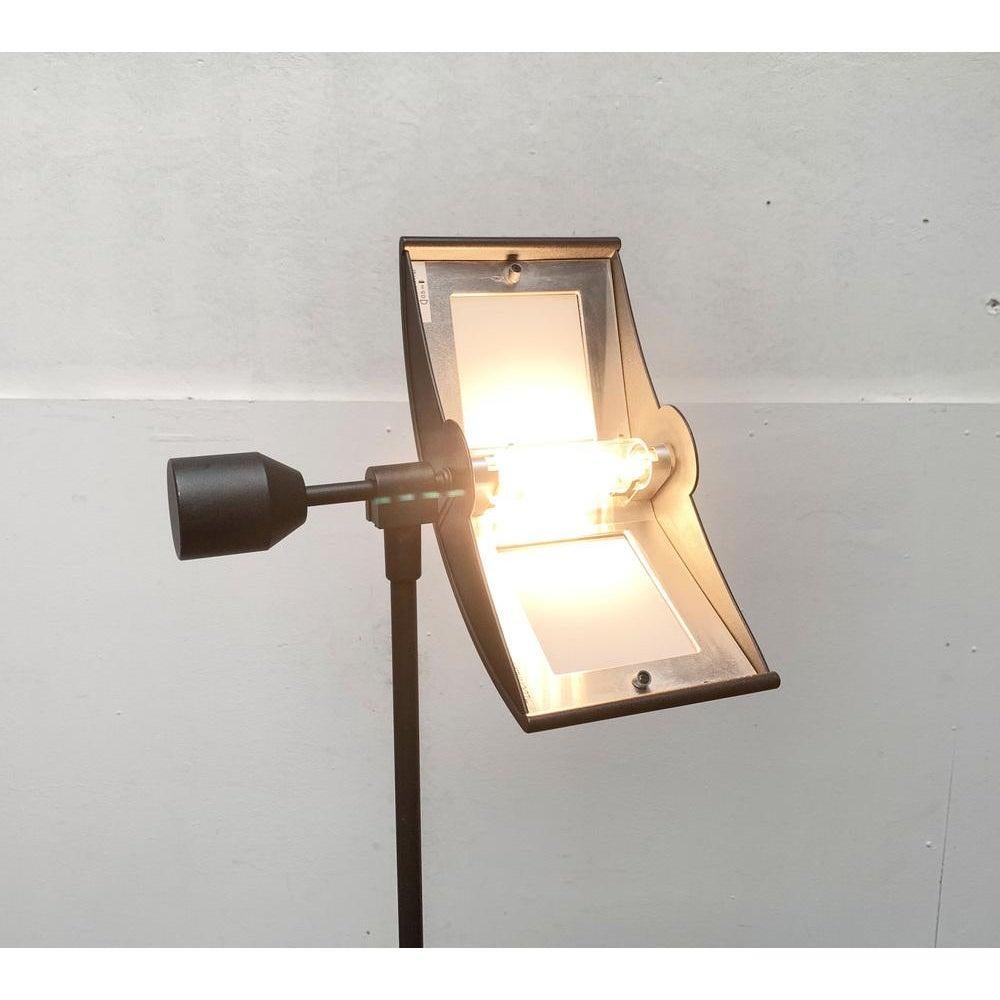 Postmodern floor lamp from the Italian manufacturer Lucitalia from the 80s.

Striking at this design is the combination of a technical design language and traditional details. The filigree tripod is composed of three individual elements, which are