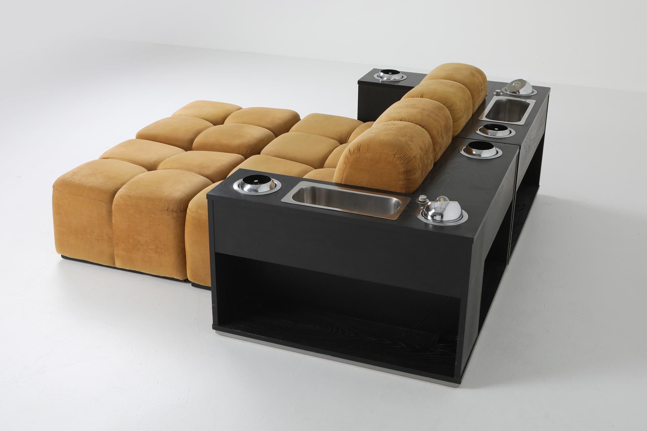Tufted sectional sofa in the style of Mario Bellini's Camaleonda

Postmodern modular couch which could also be set up as two lounge chairs.
Multi functional piece as each ebonies oak module has two book storage facilities and three chrome