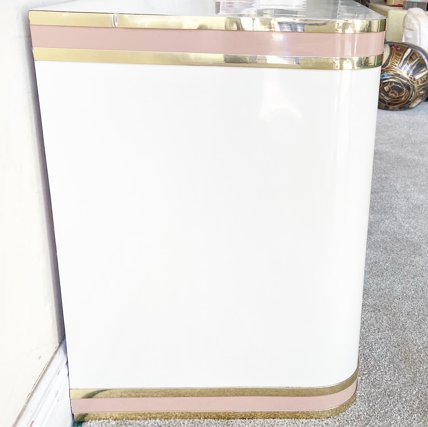 Exceptional pair of 1980s postmodern nightstands. Each display a Ivory lacquer laminate with a pink and gold trim.
 