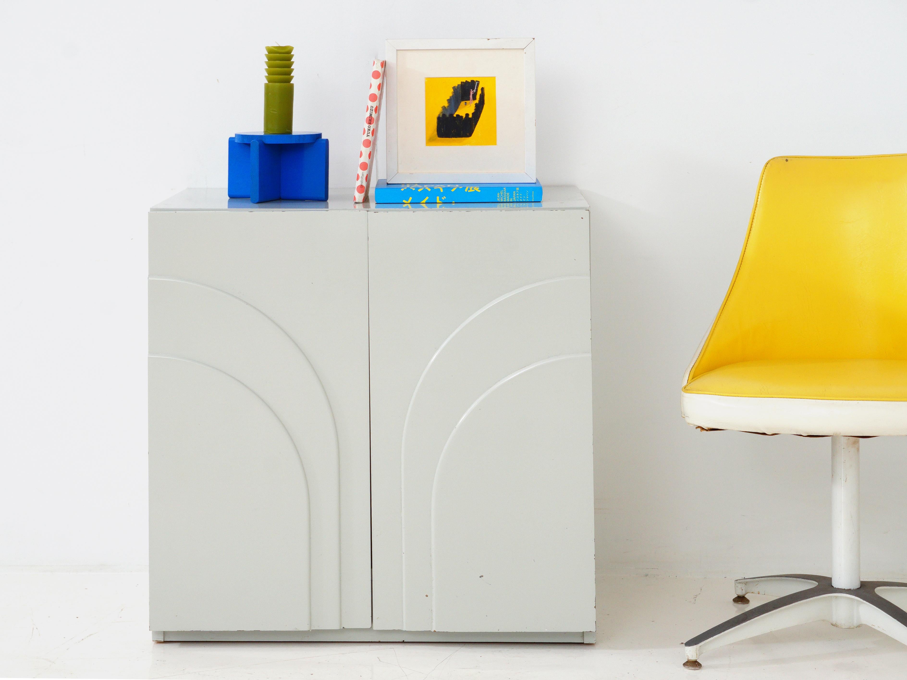 Behold, the 1980s postmodern lacquered cabinet – a true rebel with a glossy cause. With its bold geometry and high-shine finish, it's the rockstar of storage solutions, refusing to blend into the background. This cabinet isn't just a piece of