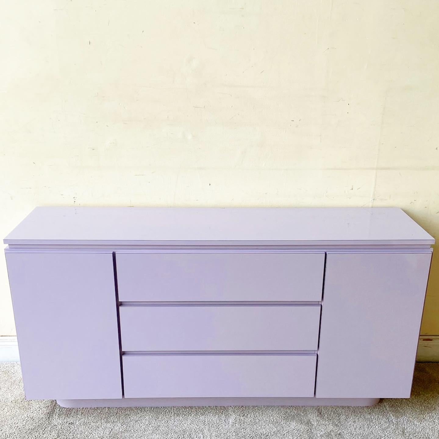 Amazing vintage Postmodern credenza. Features a lavender lacquer laminate with 3 large spacious drawers and town cabinet doors on each side.