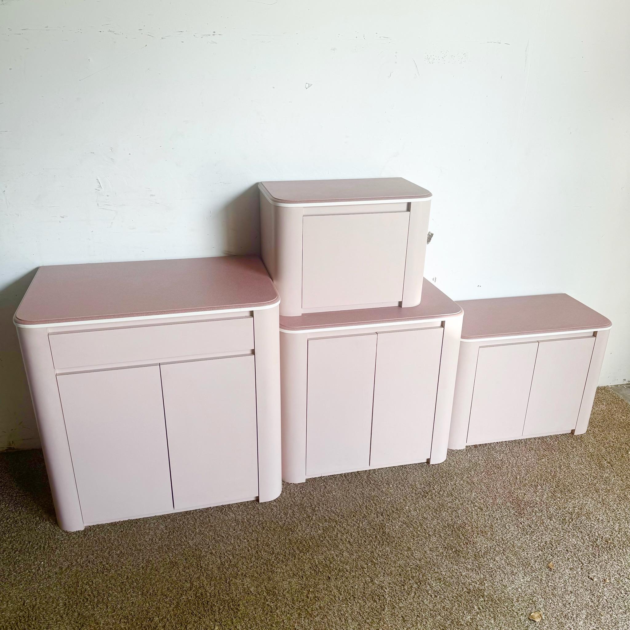 Questo mobile postmoderno in laminato color lavanda è caratterizzato da un design sorprendente con piani in fusione rosa, che aggiungono un tocco vivace a qualsiasi spazio. Composto da quattro pezzi, questo versatile mobile può fungere da bar o da