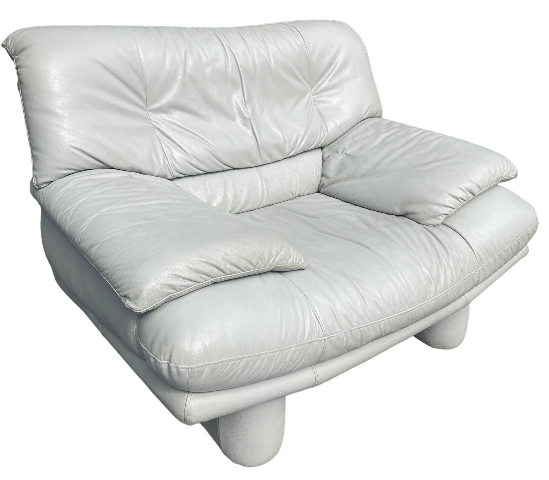 Iconic postmodern creamy white/light gray armchair with a lived in charming vintage look. These are probably Natuzzi version of the Nicoletti Salotti Italian leather sofa and armchair line. A statement piece in your living room or anywhere you