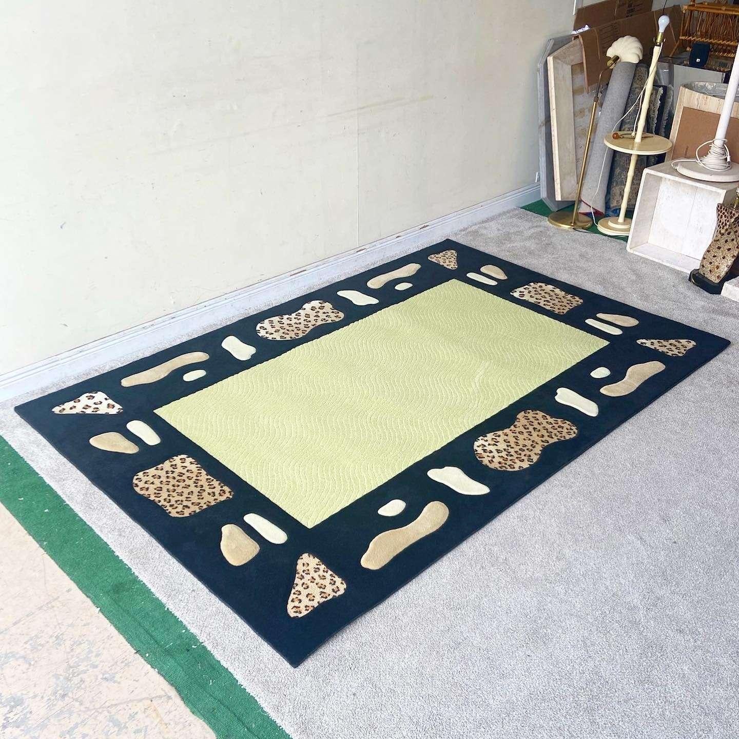 Outstanding vintage postmodern rectangular area rug. Features a green interior with a black outer border which is patterned with leopard print, tan and beige sections.

Rug 34
