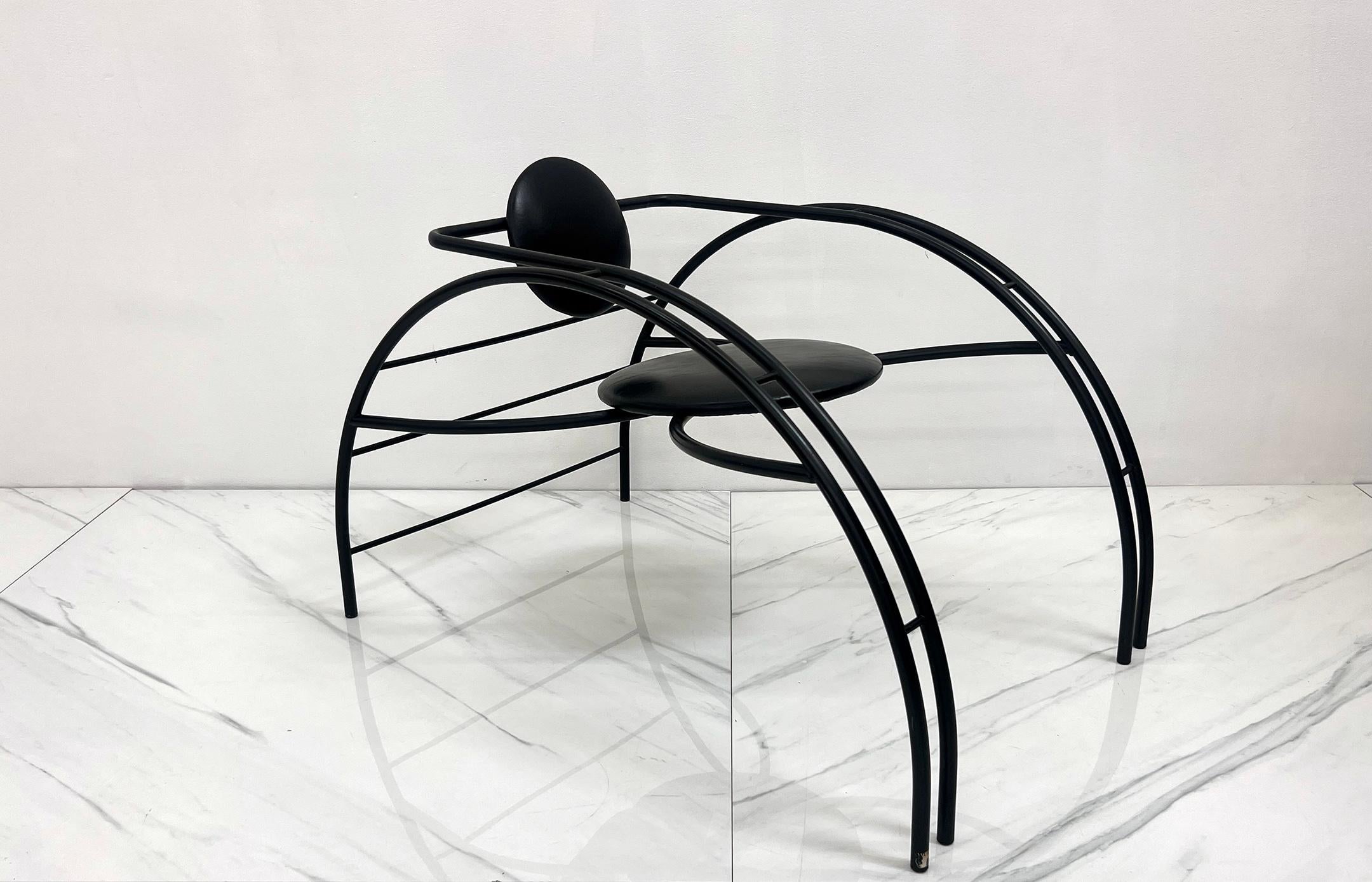 An absolutely stunning Quebec 69 spider chair by Canadian Postmodern Design Group Les Amisca. This chair was designed in the 1980s and features a rounded steel Art Deco style body with a round seat and seat back that are upholstered in its original