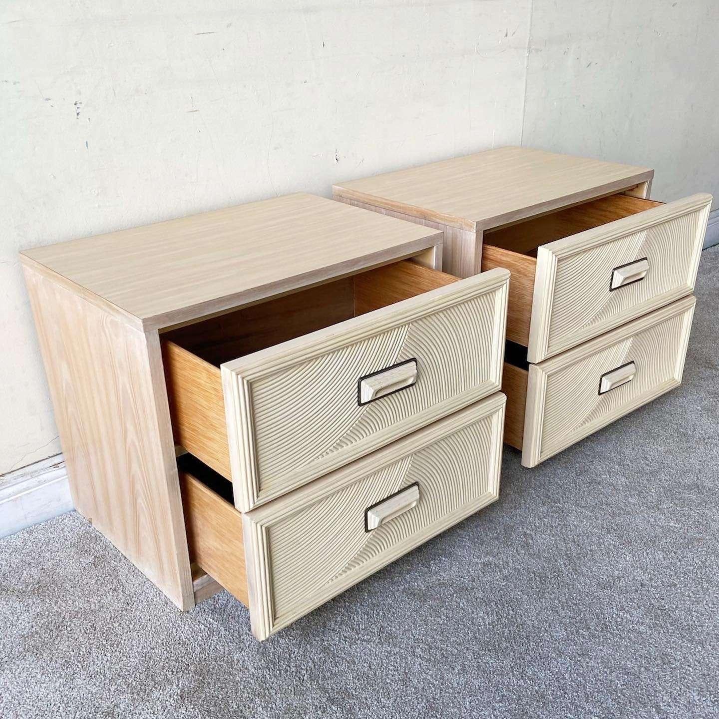 Amazing pair of vintage boho chic nightstands by Henry Link. Each features 2 spacious drawers with pencil reed drawer faces.
