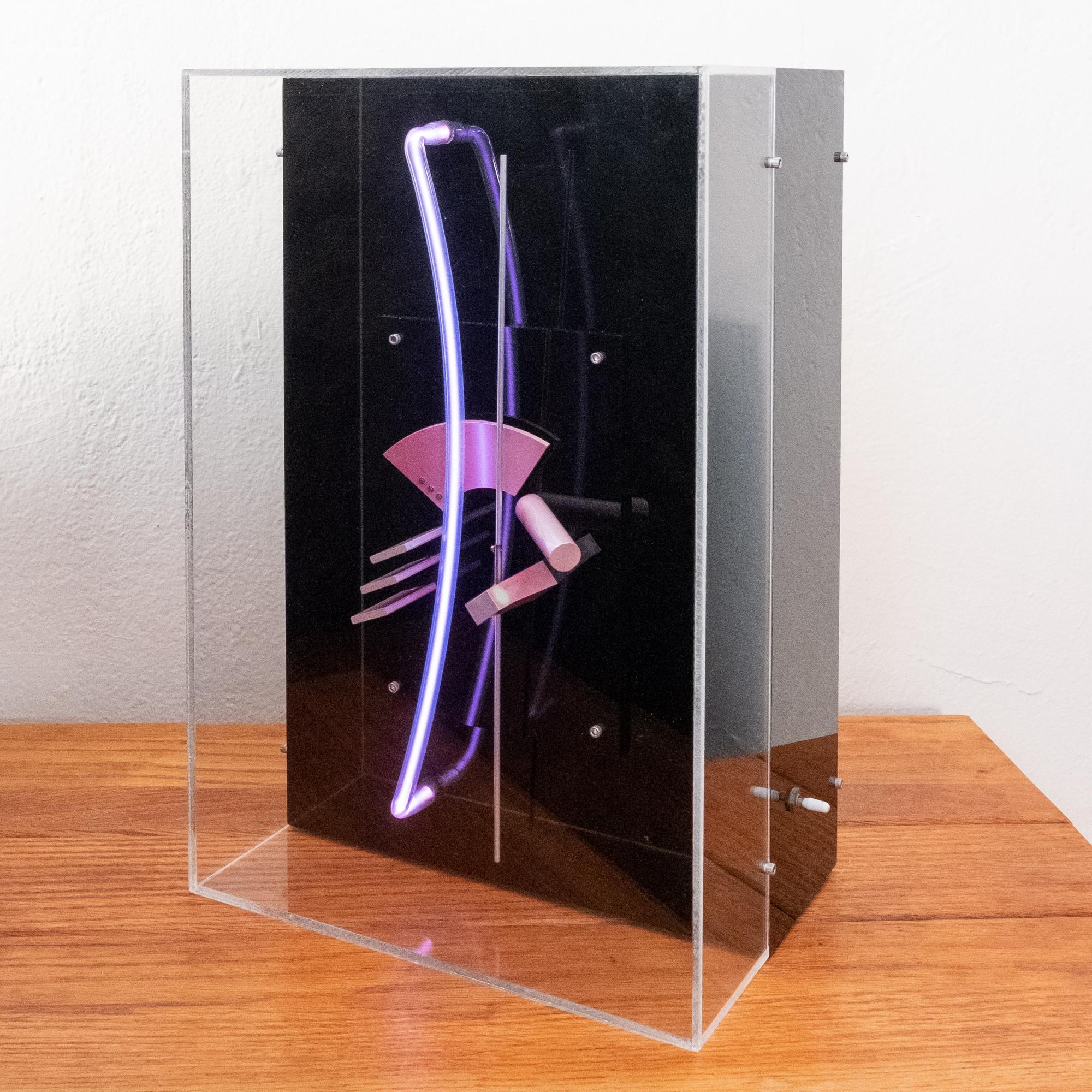 Postmodern light and space sculpture from 1983. Signed illegibly and dated, with a the title, Change of Plane IV. Constructed of brushed metal and a light tube. It is operated by a switch located on one side. It was purchased from the estate of a