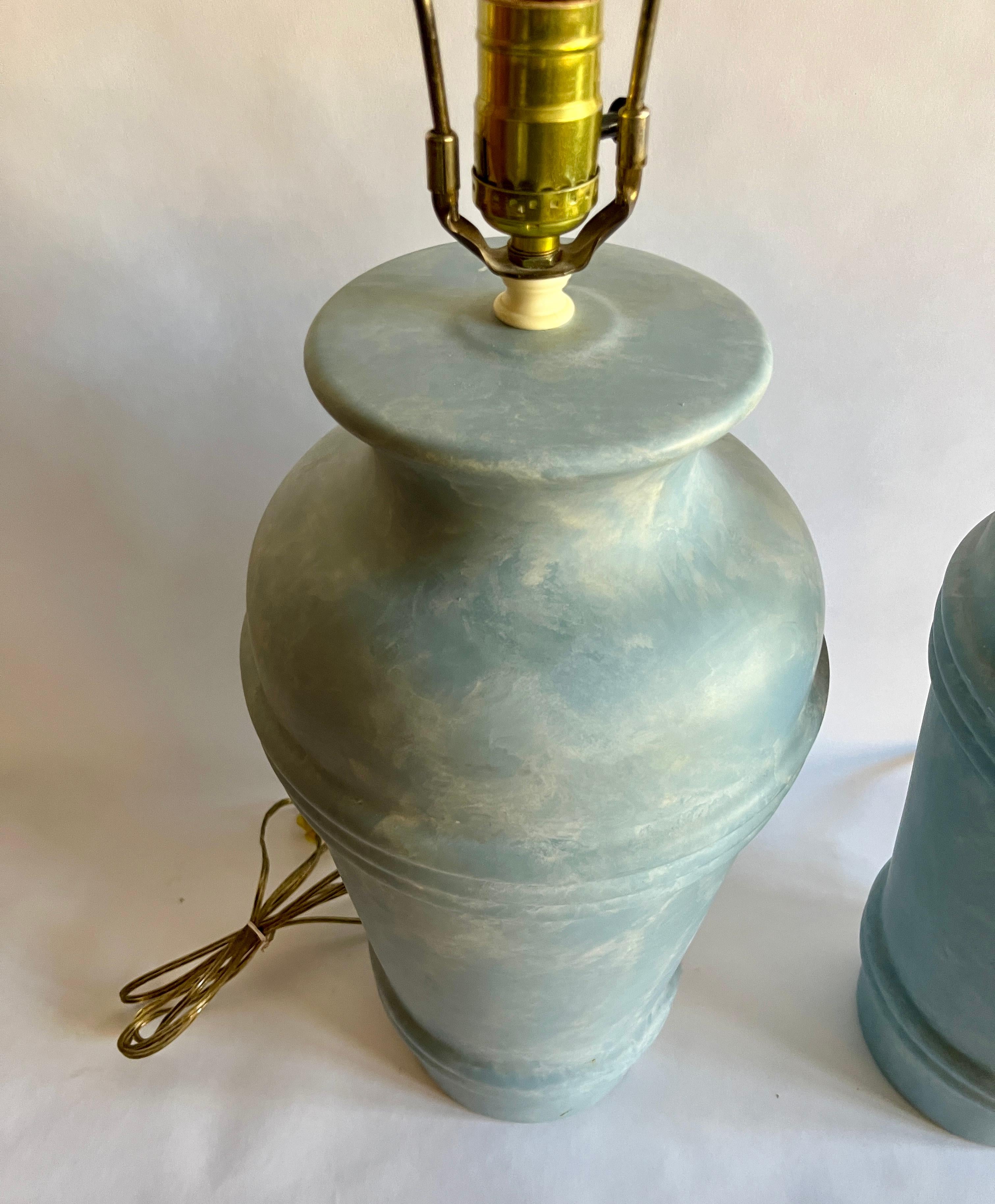 Pair of Post-modern ceramic table lamps by Regal China with two sets of ribbed banding and swirled light blue glaze. Original wiring in working order. Includes harps. No lampshades included.

Each measures 18