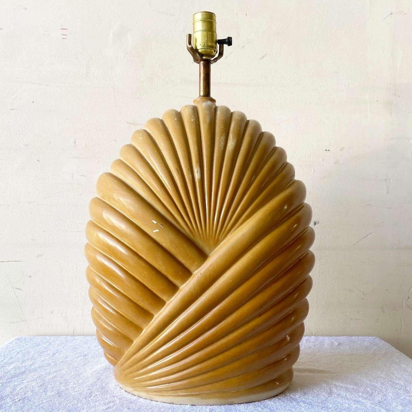 Wonderful vintage postmodern ceramic table lamp. Features a scalloped body with a light brown finish.