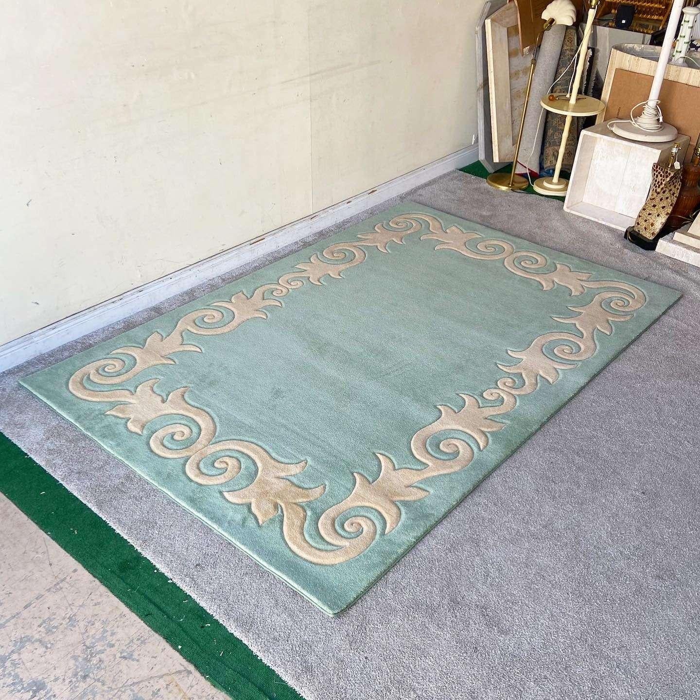 Exceptional vintage postmodern rectangular area rug. Features a light green interior and outer edge with a pink sculpting vining around the edge of the carpet.

Rug 23
