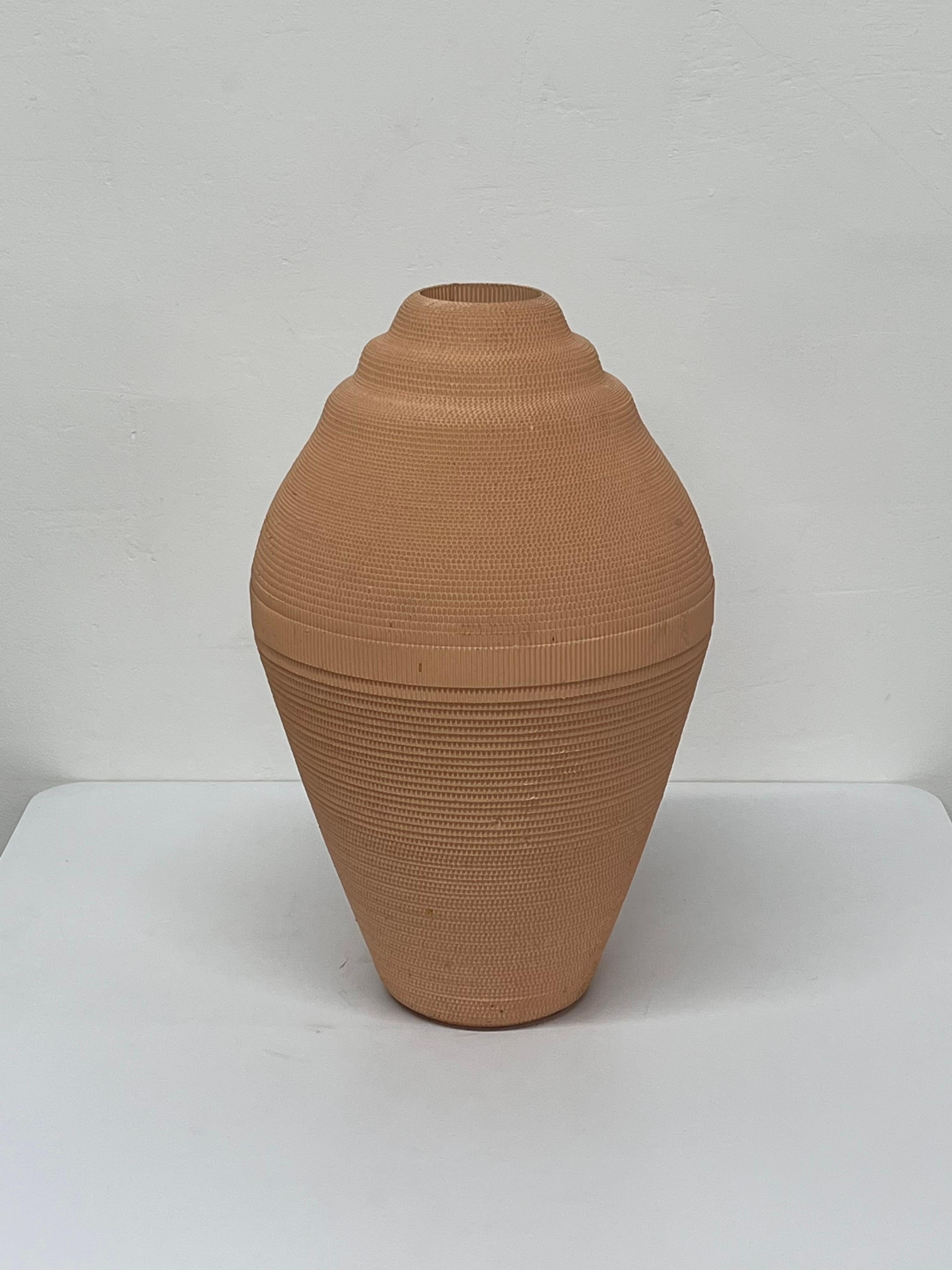 Corrugated cardboard vase rendered in light peach by Flute, Chicago circa 1980s. Best to use with dried arrangements.