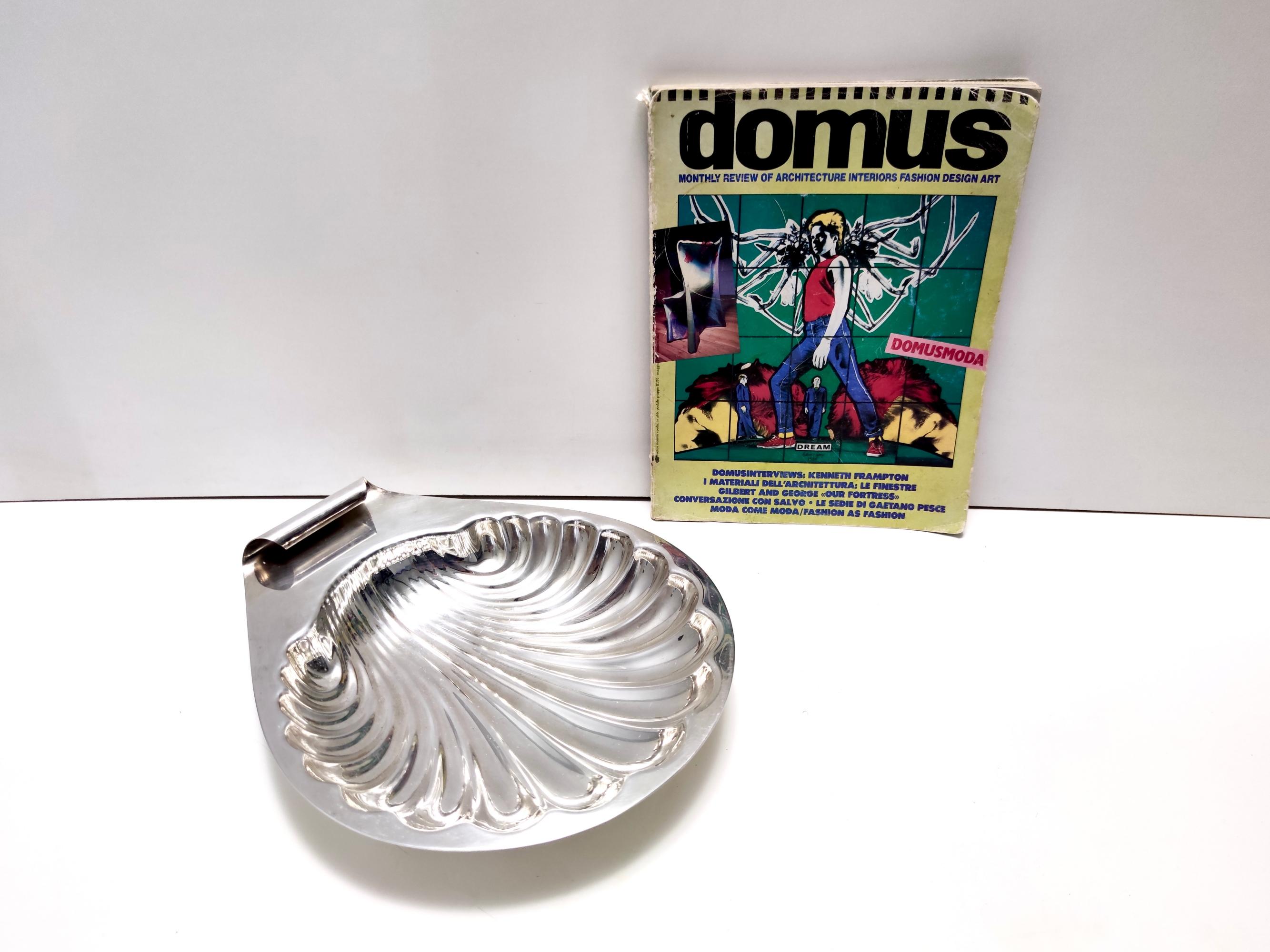 Made in Italy, 1970s.
This is a great silver plated brass vide-poche in the shape of a shell.
Its simple design was created by Lino Sabattini. 
This is a vintage piece, therefore it might show slight traces of use, but overall it can be considered