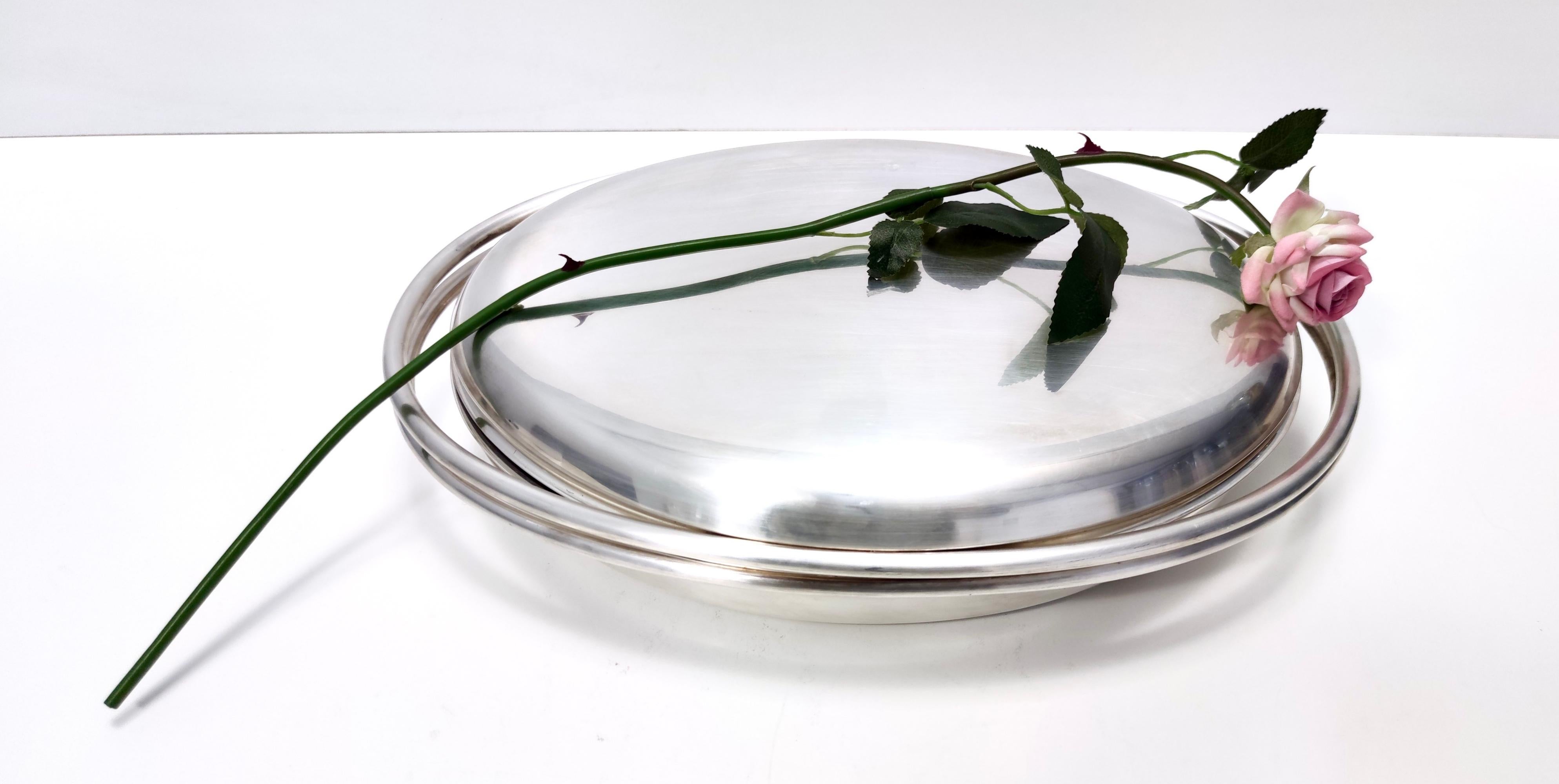 Made in Italy, 1970s - 1980s.
This is a great silver plated metal serving dish.
Its simple design was created by Lino Sabattini. 
This is a vintage piece, therefore it might show slight traces of use such as its original patina, but overall it can