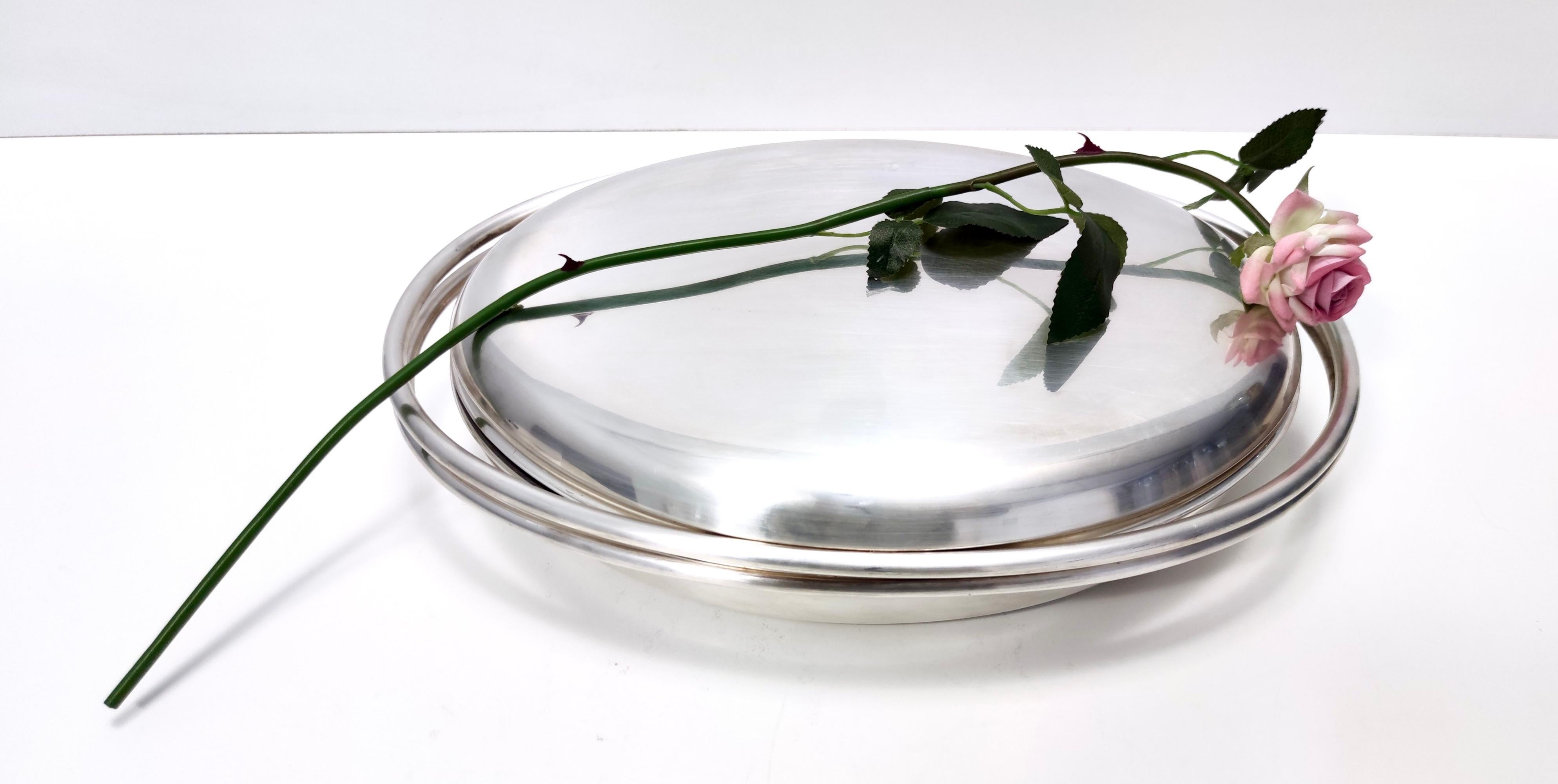 Fabricado en Italia, años setenta - ochenta.
Este es un gran plato de metal plateado para servir.
Su sencillo diseño fue creado por Lino Sabattini. 
Se trata de una pieza de época, por lo que puede mostrar ligeras huellas de uso como su pátina