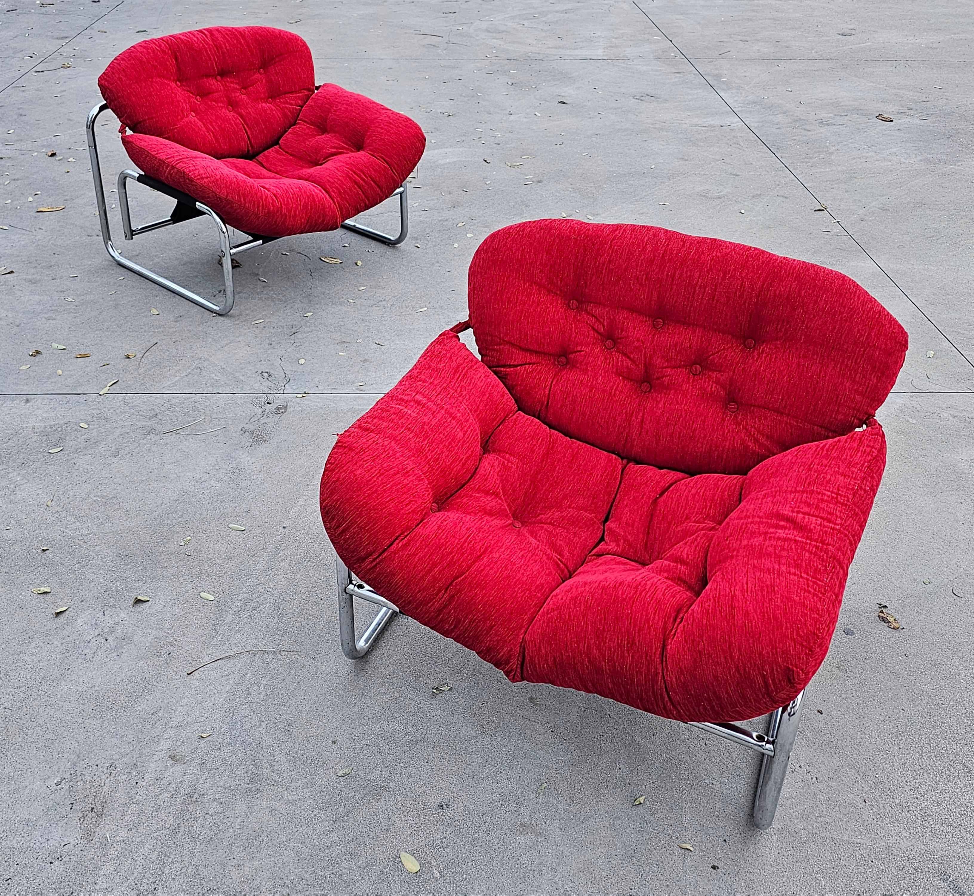 In this listing you will find two Postmodern Lounge Chairs designed by Johan Bertil Häggström for Swed Form. The chair features a Bauhaus-style tubular chrome frame with a fluffy, large seat made of red velvet, which makes these chairs very