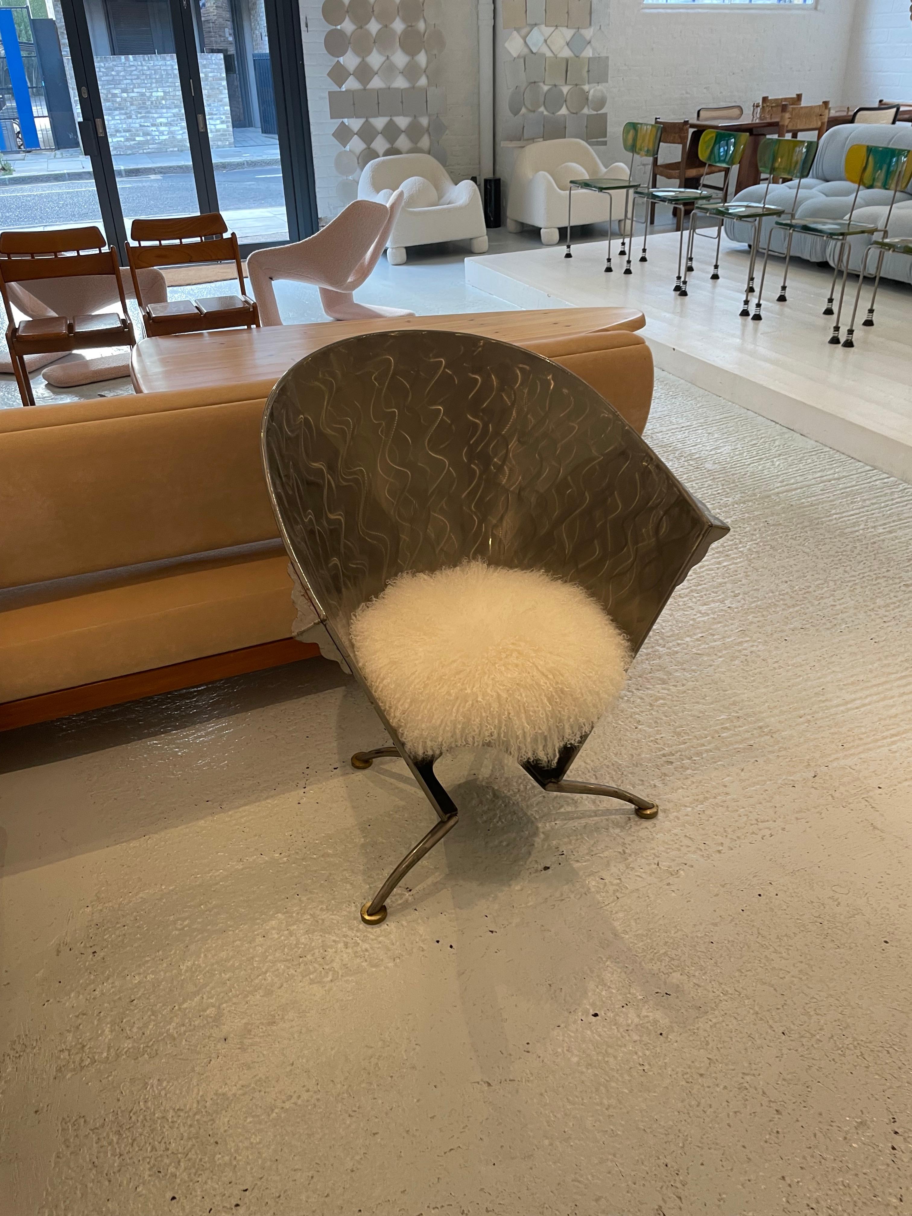 Made from Steel on brass feet in the 1980s – 90s. The seat has been upholstered in White Mongolian Sheepskin.