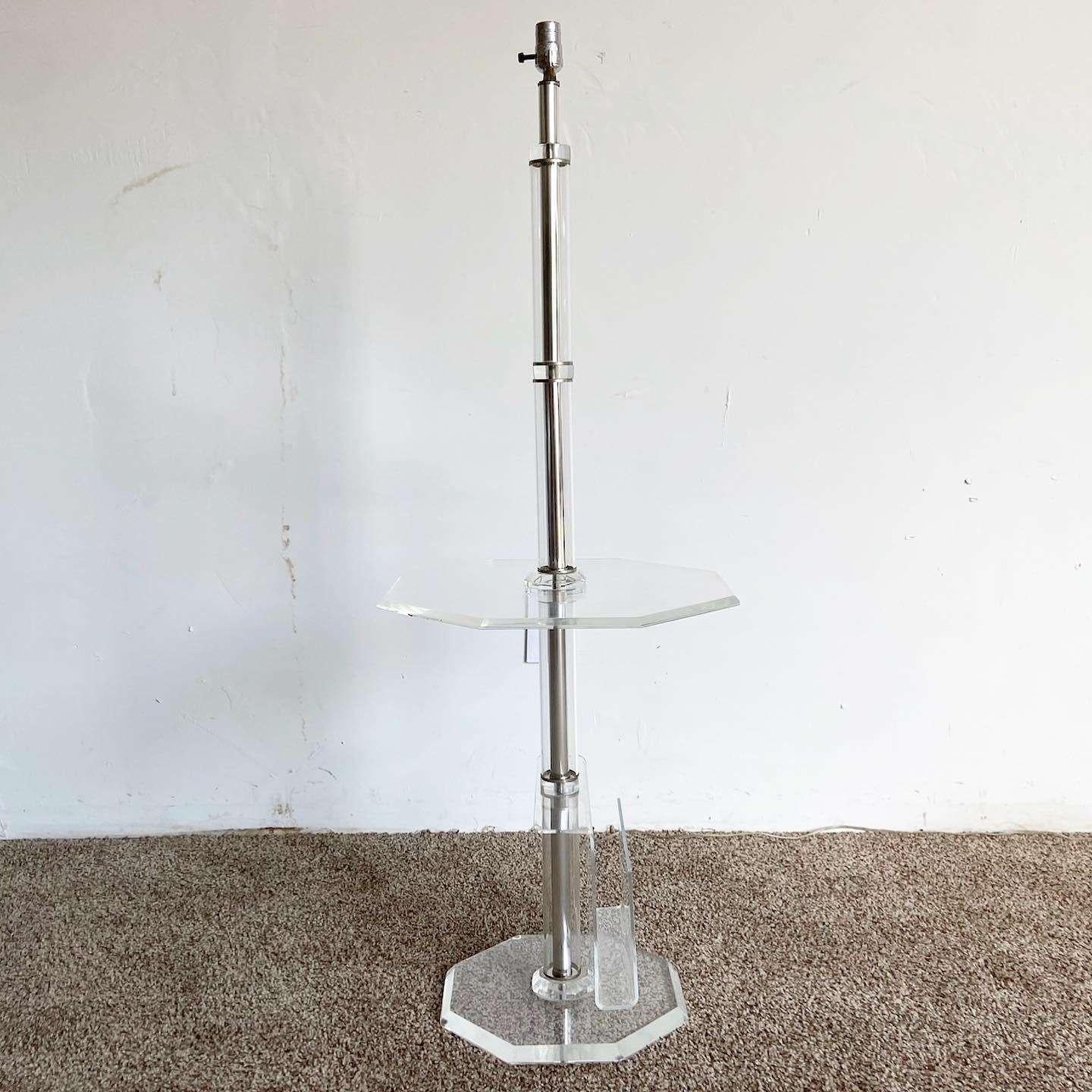 Exceptional vintage postmodern lucite floor lamp/side table with a magazine rack at the bottom. The stem displays a good interior through the stacked lucite sections. 