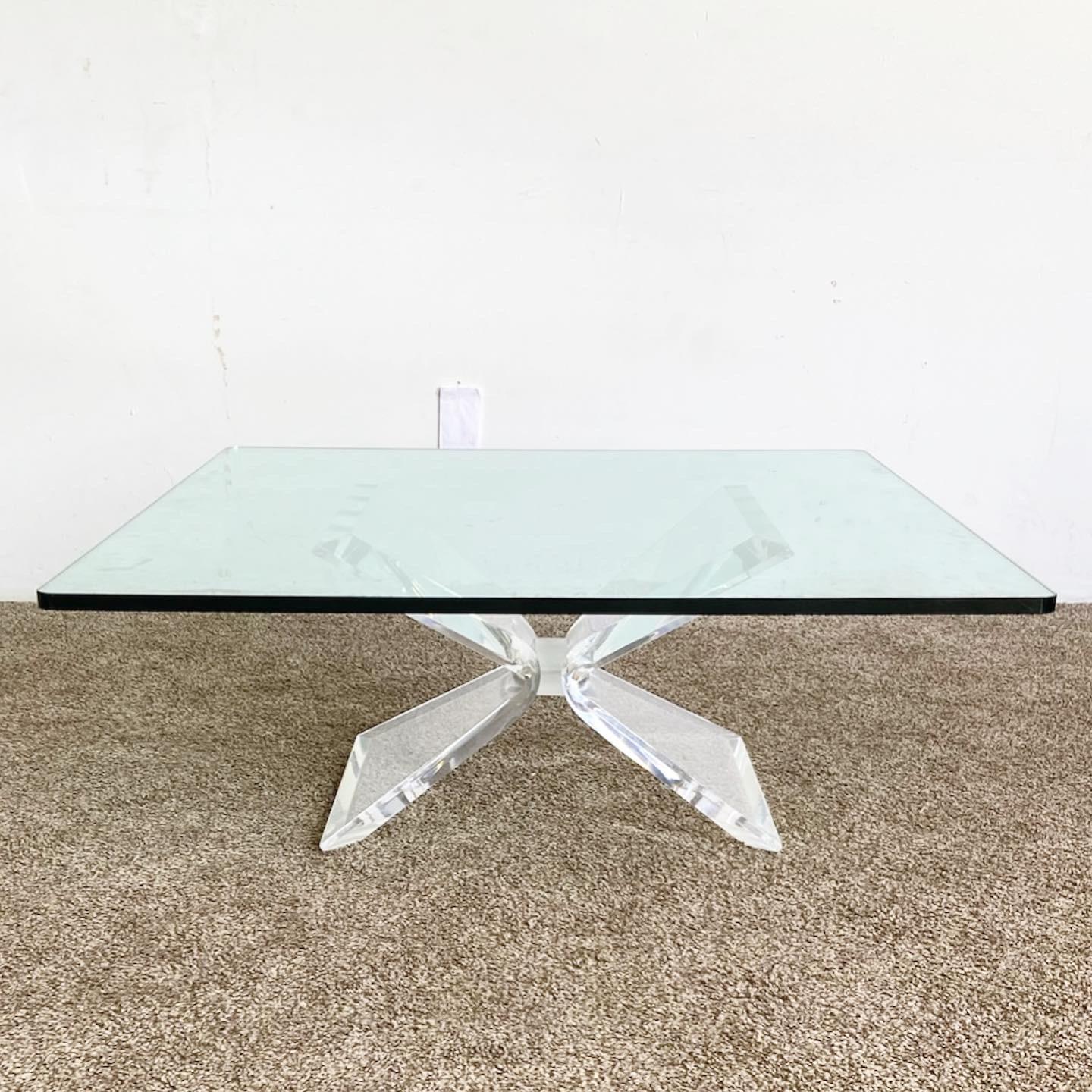 Introduce a splash of postmodern style to your living room with this Postmodern Lucite Glass Coffee Table. With its vintage square glass top and sculpted lucite base, this coffee table is an artful blend of form and function.
Some wear on the