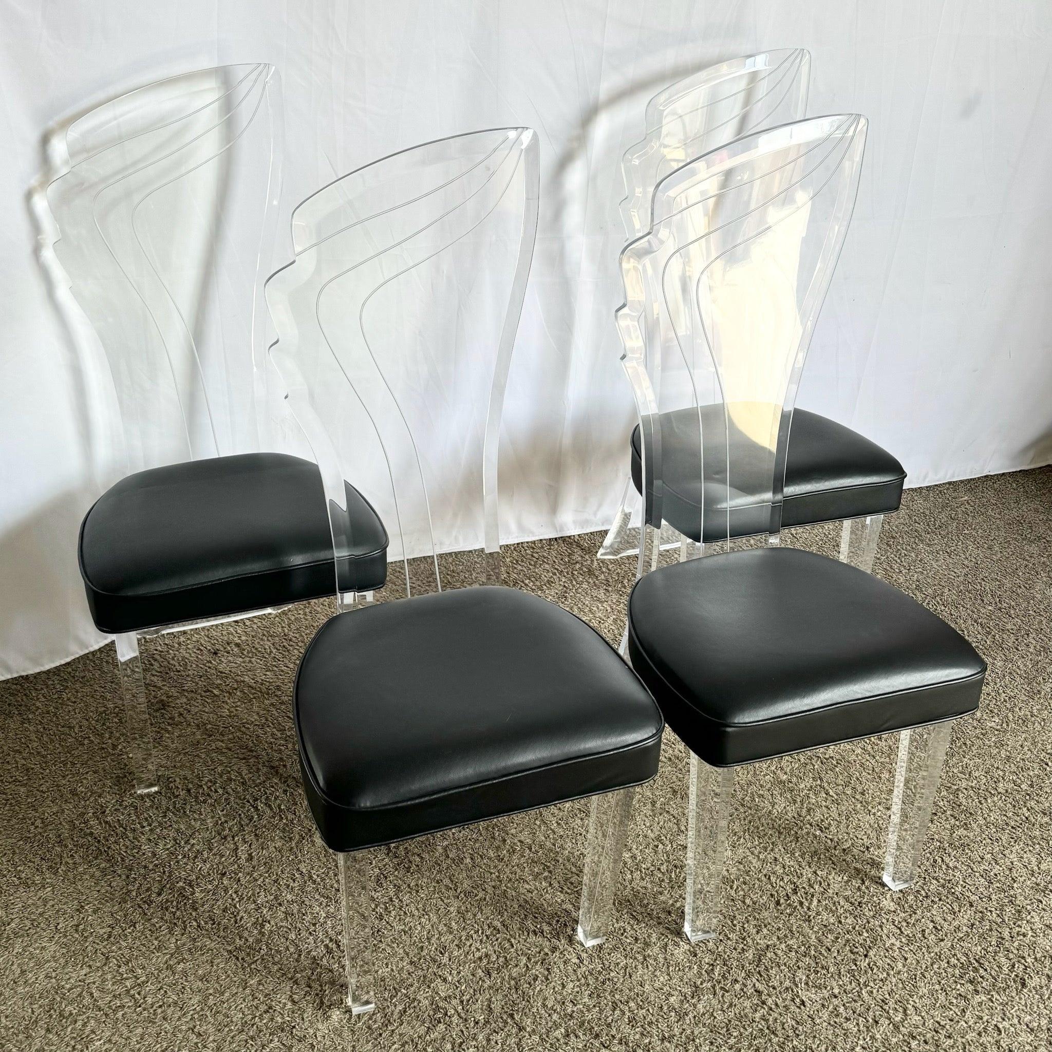 Postmodern Lucite High Back Dining Chairs—set of four with sculptural silhouettes and 1980s glamour for vintage sophistication.​
 
 We sell items as acquired, without restoring or repairing. Vintage pieces may have age-related wear. Review photos