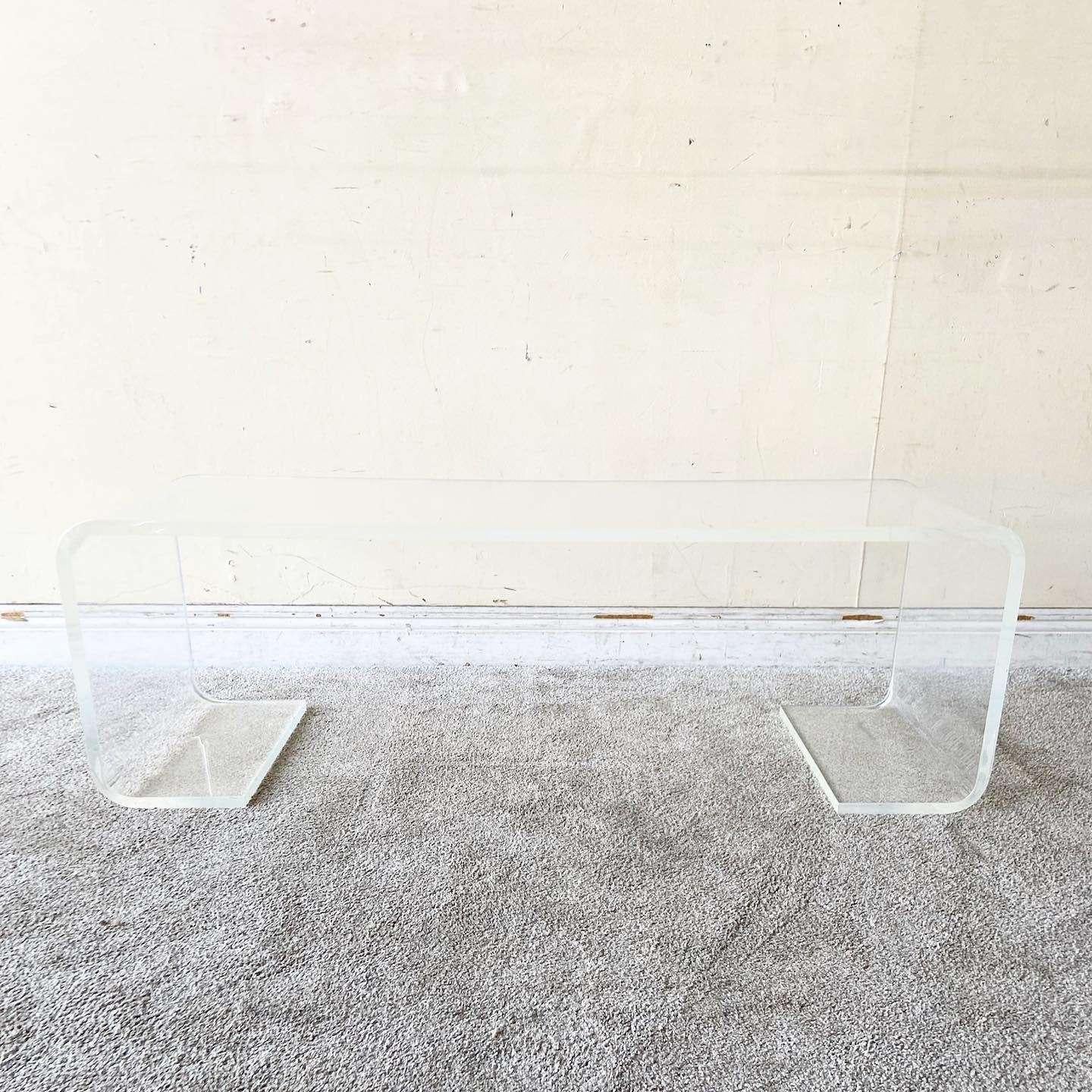 Wonderful vintage lucite scroll coffee table. Features double waterfall edges and a thin rectangular shape.