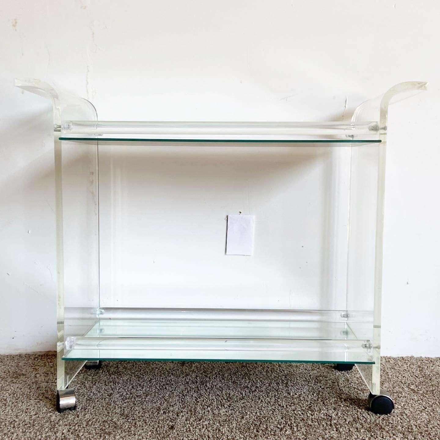 Amazing vintage postmodern lucite bar cart. Features two mirrored shelves.