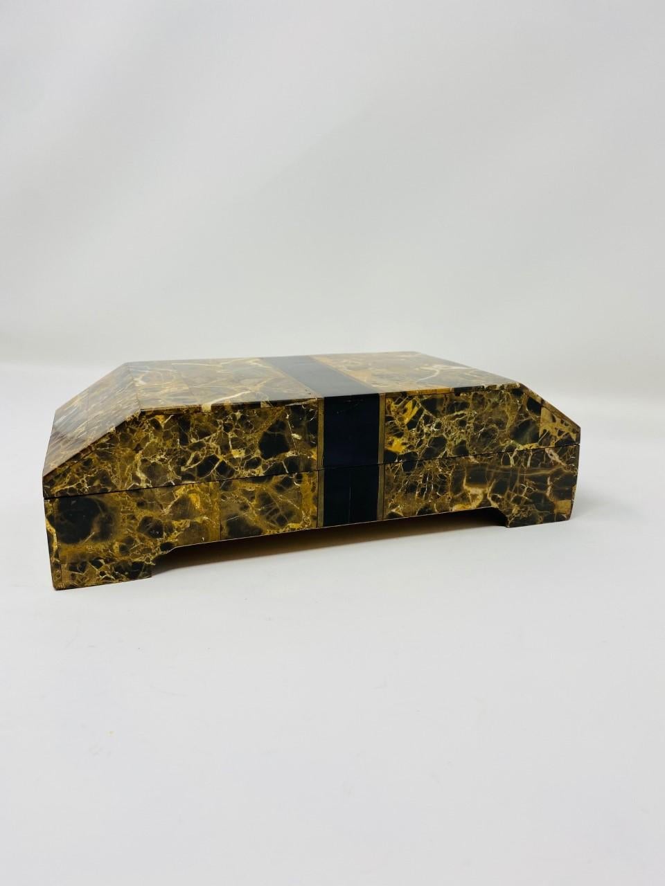 This beautiful box by Maitland Smith exudes style and glamour. This design from the late 1970s is glamorous and functional. The postmodern lines in almost a pedestal structure, are covered in a beautiful veined travertine marble in hues of light