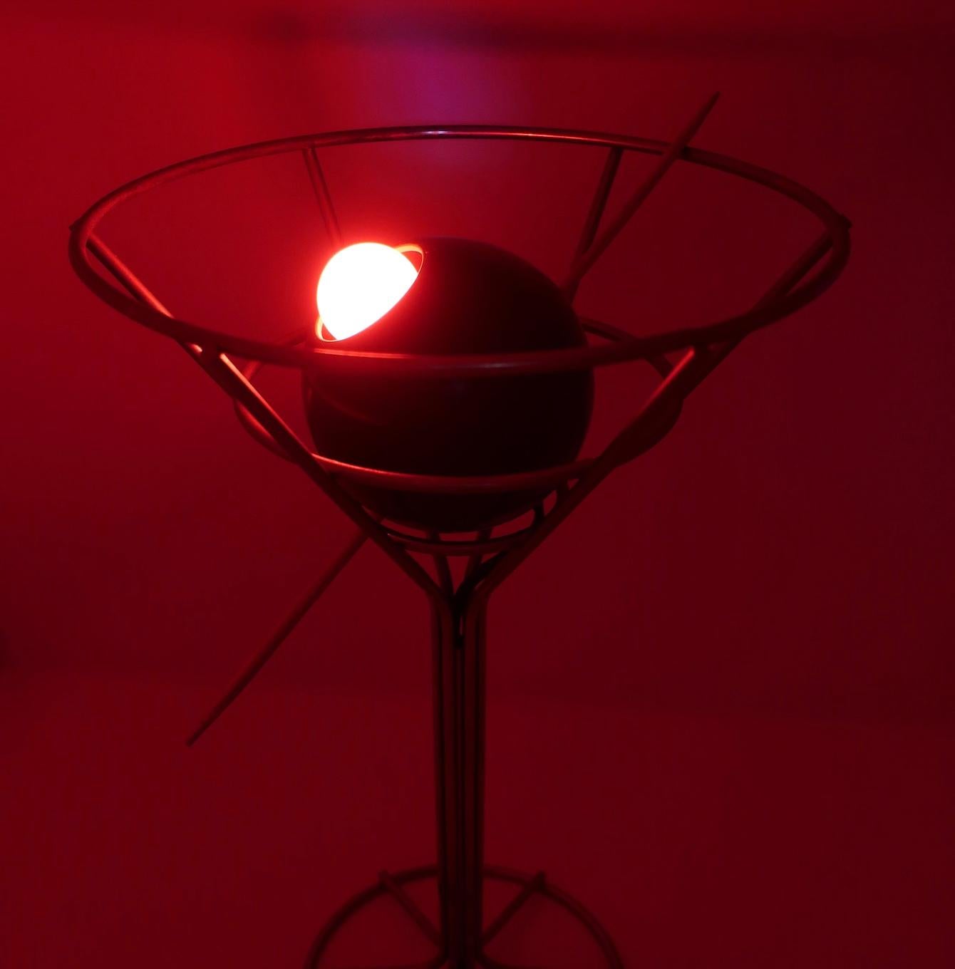 A rare 1993 postmodern martini lamp designed by David Krys. Metal wire forms the glass' shape with a skewered green olive stuffed with a red light bulb disguised as a pimento. Great for lovers of pop art, barware, martinis, or awesome lamps!

In