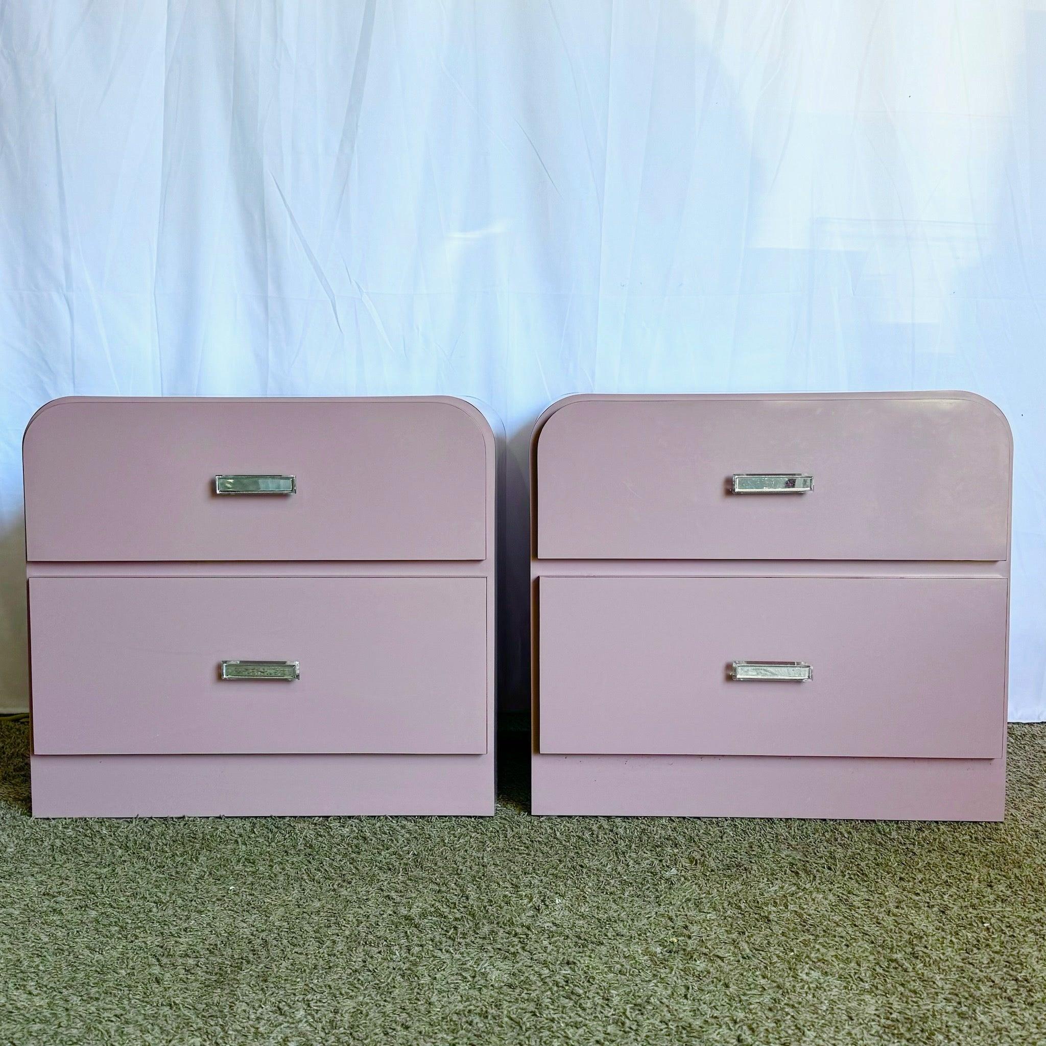 Pair of Postmodern mauve laminate waterfall nightstands with sleek edges and Lucite handles, perfect for adding modern elegance to your bedroom.
 
 Minor wear to the handles as shown in the photos.
 
 We sell items as acquired, without restoring or