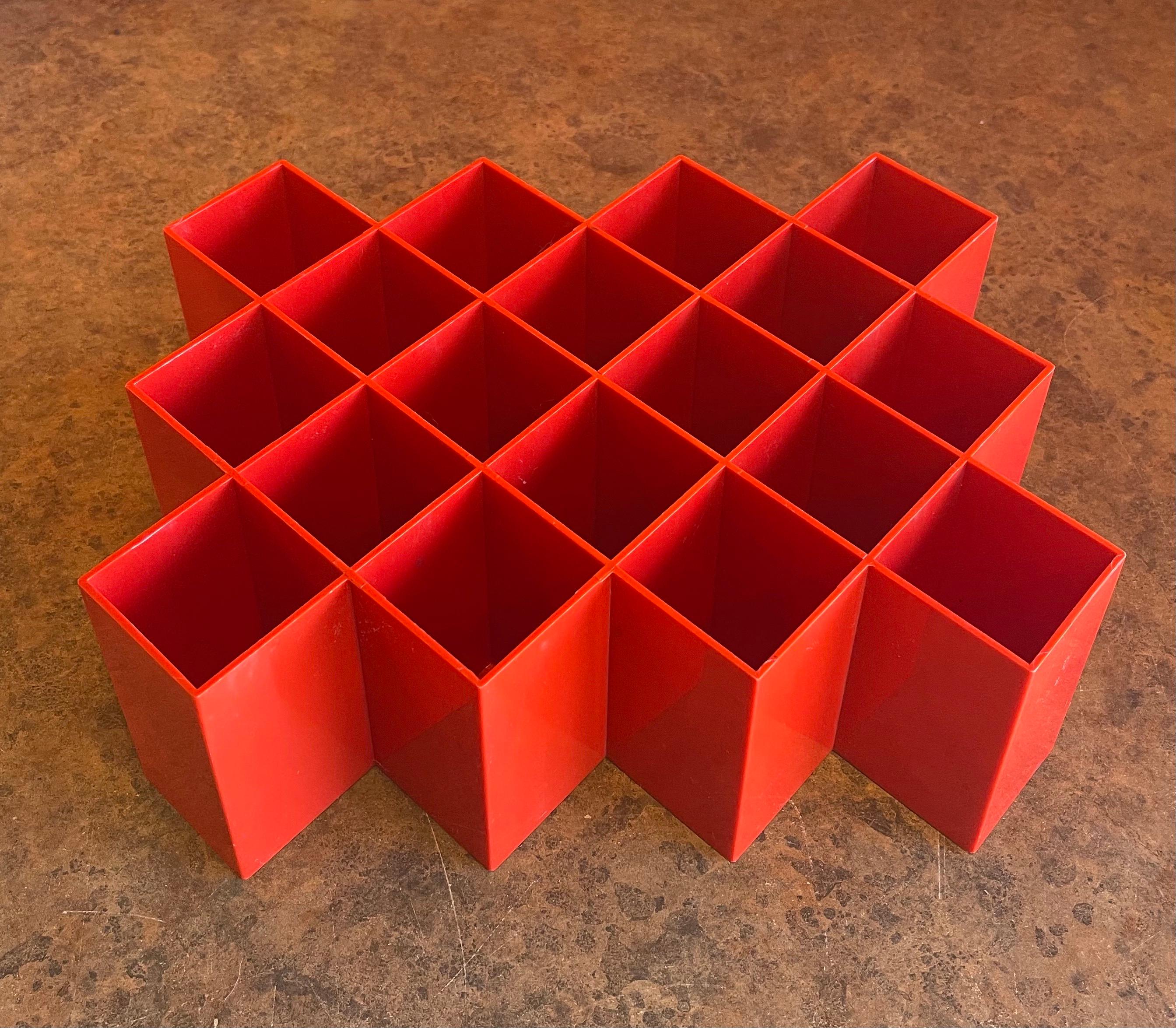 A very cool postmodern / memphis design hanging spice rack by Copco, circa 1980s. The piece is in very good vintage condition and is made of molded, bright red plastic. It measures 11.5