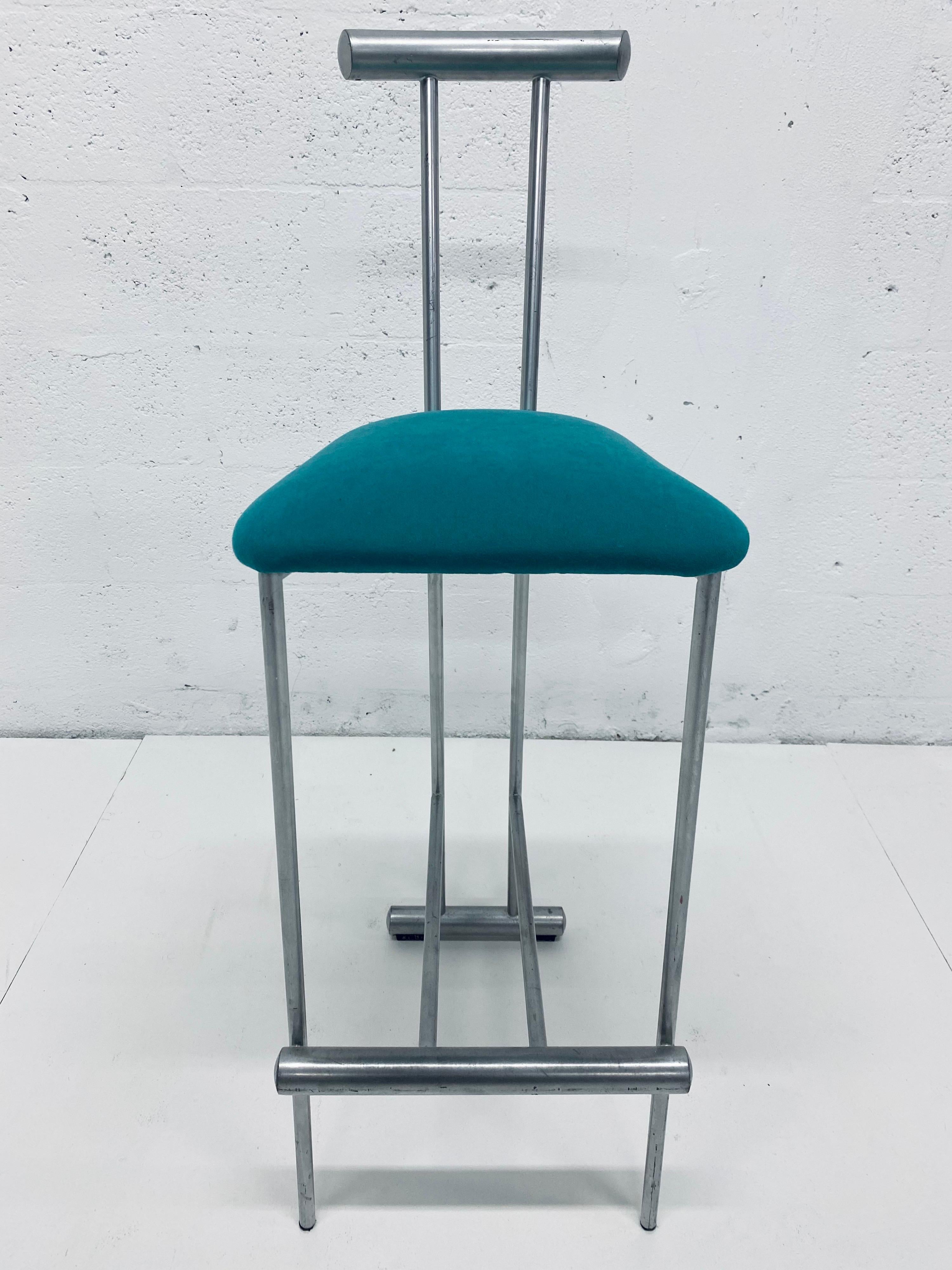 Single bar stool in the style of Memphis Milano circa 1980s. Teal fabric cover is easily replaceable. Gray tubular steel frame.