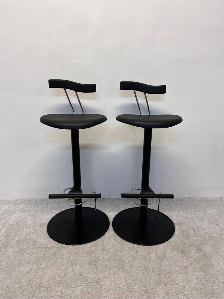 Pair of bar height Italian post modern bar chairs inspired by Memphis Milano. Made of black lacquered steel with black moulded rubber seats and backs. 

 