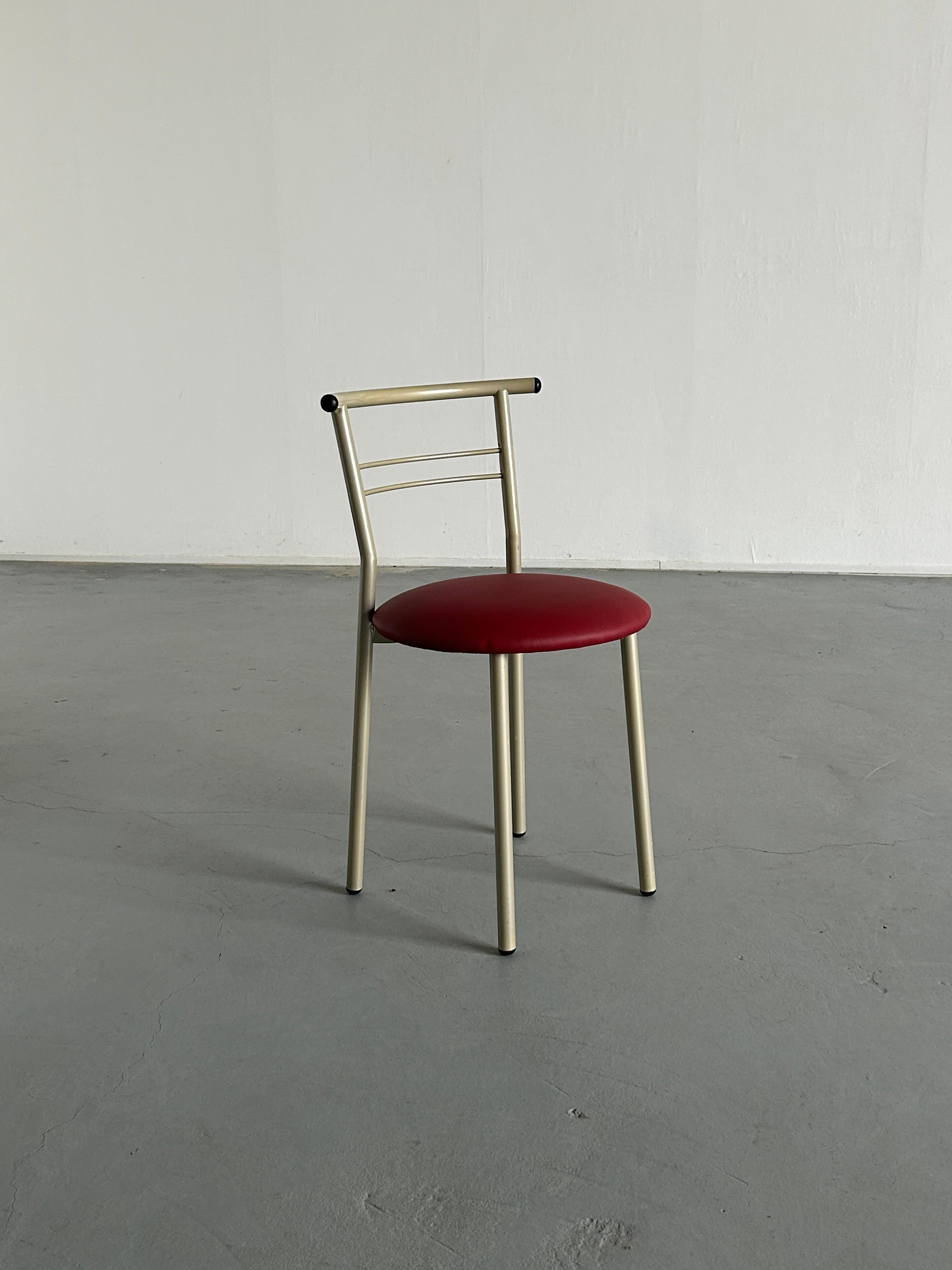 A unique vintage postmodern Memphis Milano style dining or accent chair, made from metal, with a red faux leather reupholstered seat.

Overall in very good vintage condition with expected signs of age, highlighted in the photos. 
Structurally