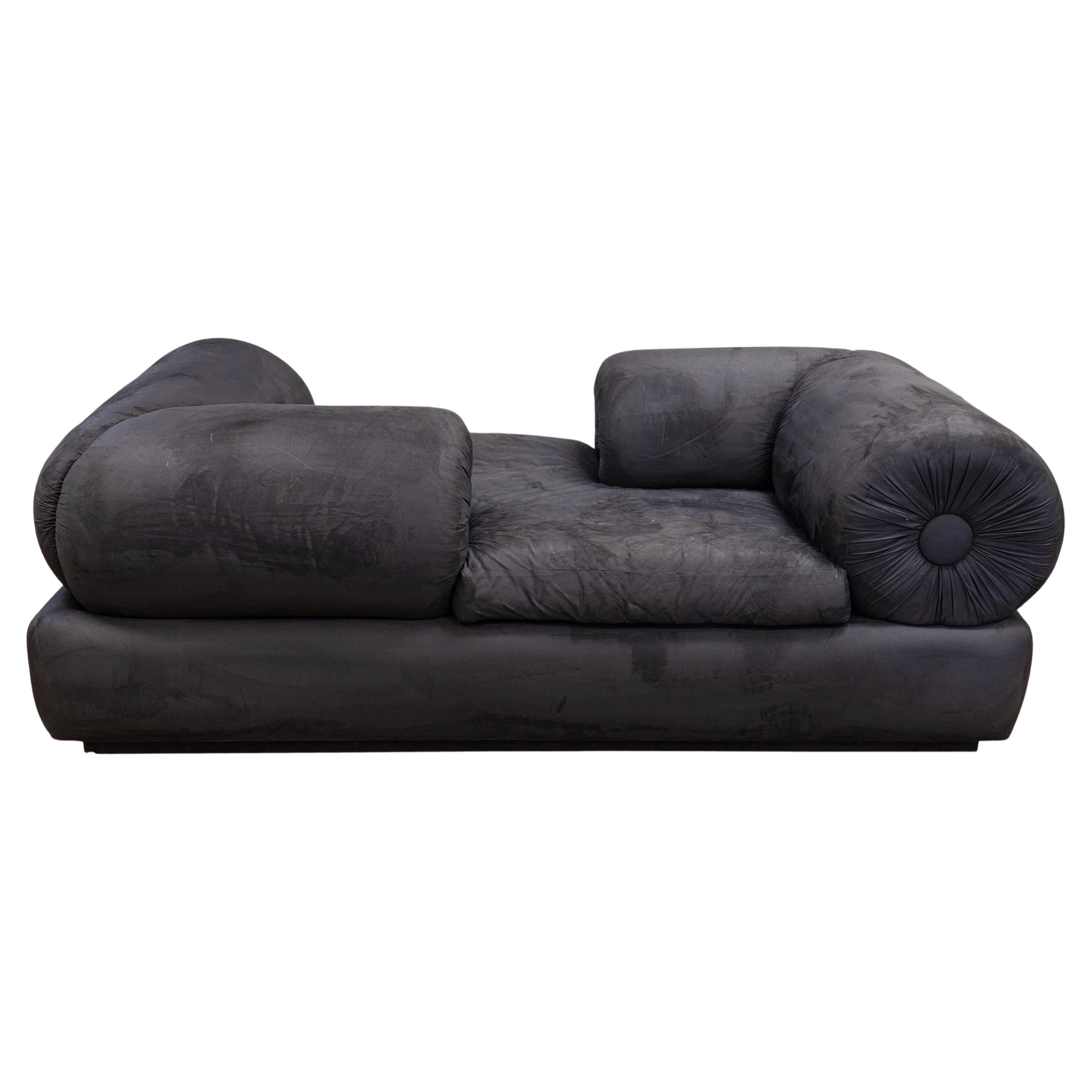 A postmodern Memphis style tete a tete sofa. A stunning piece of furniture with a very unique design. This piece features a super chic black velvet upholstery, with tufted features on the arms. This sofa also has a very interesting tete a tete
