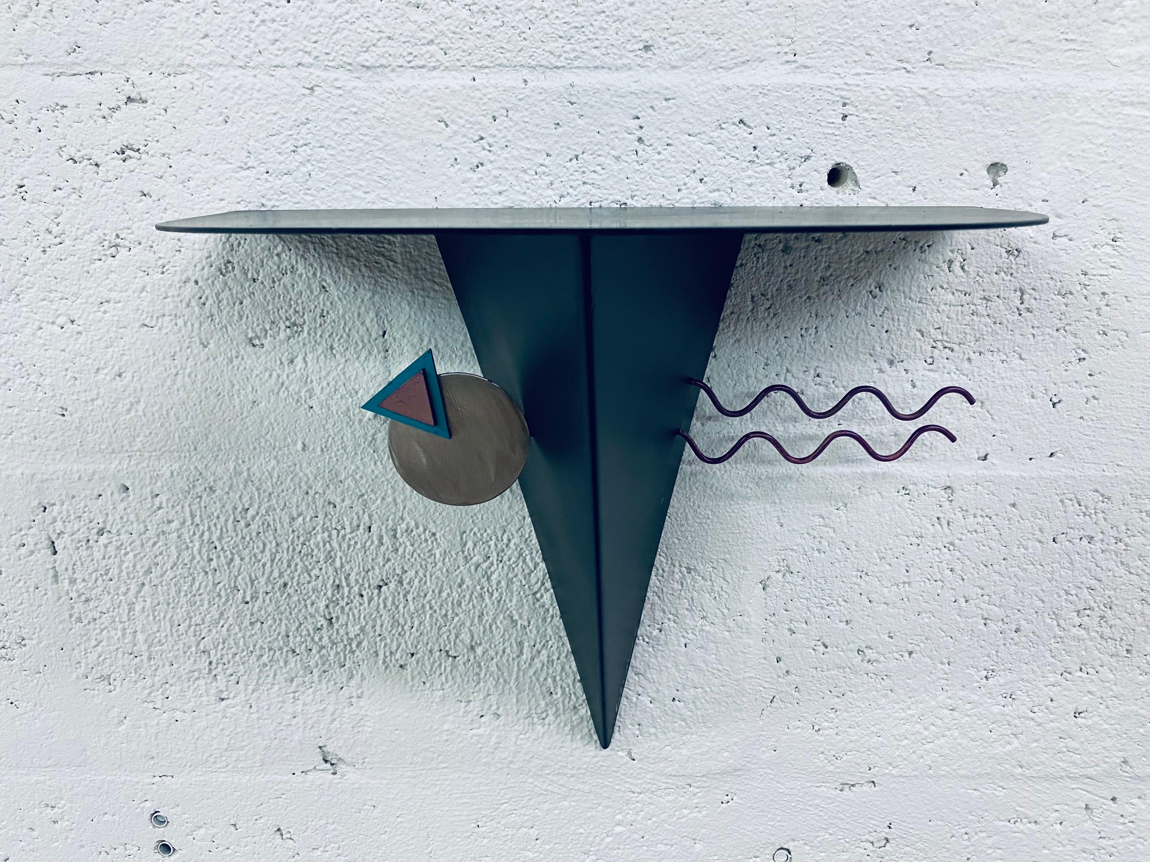 Artist signed postmodern Memphis style wall shelf with half circle top, Circa 1980s.  There are three shelves available with different shaped tops, see other listings at That Galerie.