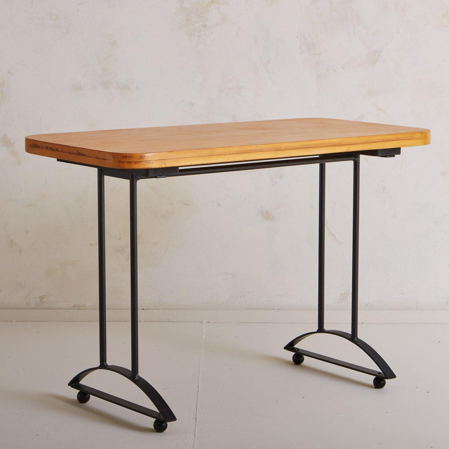 A Postmodern desk featuring a rectangular birch table top with rounded corners and beautiful graining. It has a black metal base with tubular legs and demilune details with round feet. Sourced in France, 20th Century.

