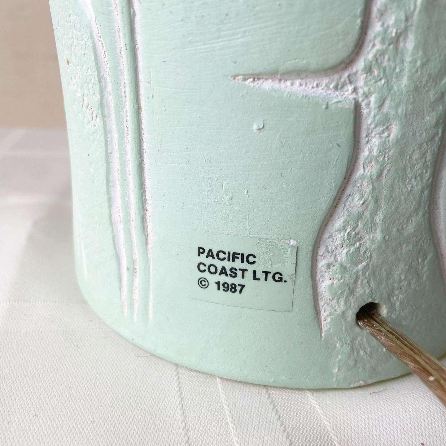 Amazing Postmodern ceramic table lamp by Pacific Coast Lighting. Features a mint green finish with etched banana leaves.
