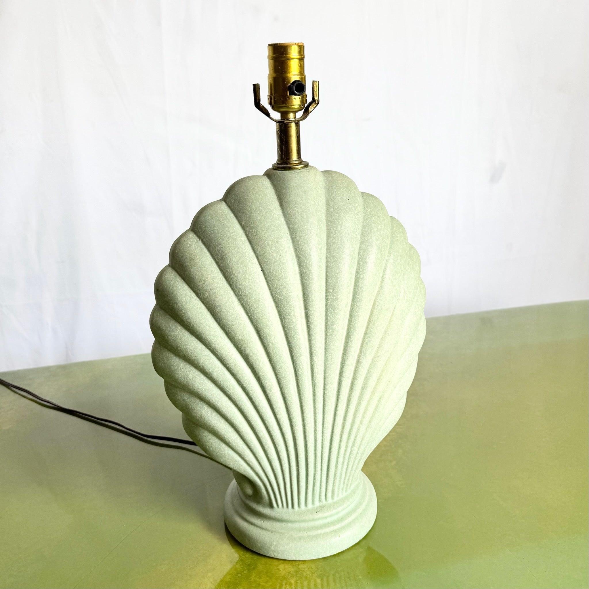 Add coastal flair with this Postmodern Mint Green Clam Shell Lamp—sculptural ceramic base, etched detailing, and brass accents.
 

 We sell items as acquired, without restoring or repairing. Vintage pieces may have age-related wear. Review photos