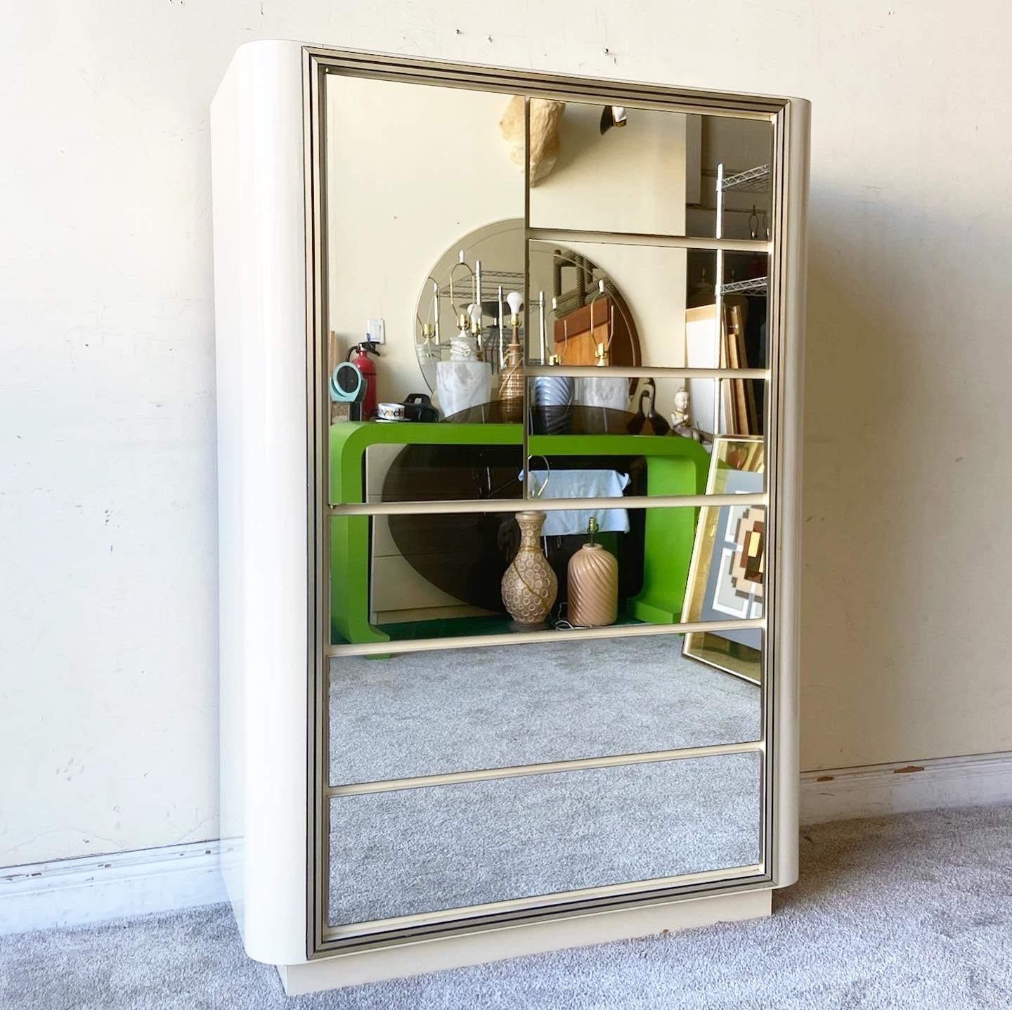 Incredible vintage postmodern highboy dresser/armoire. Features mirrored drawer and cabinet faces with a cream lacquer laminate.
 