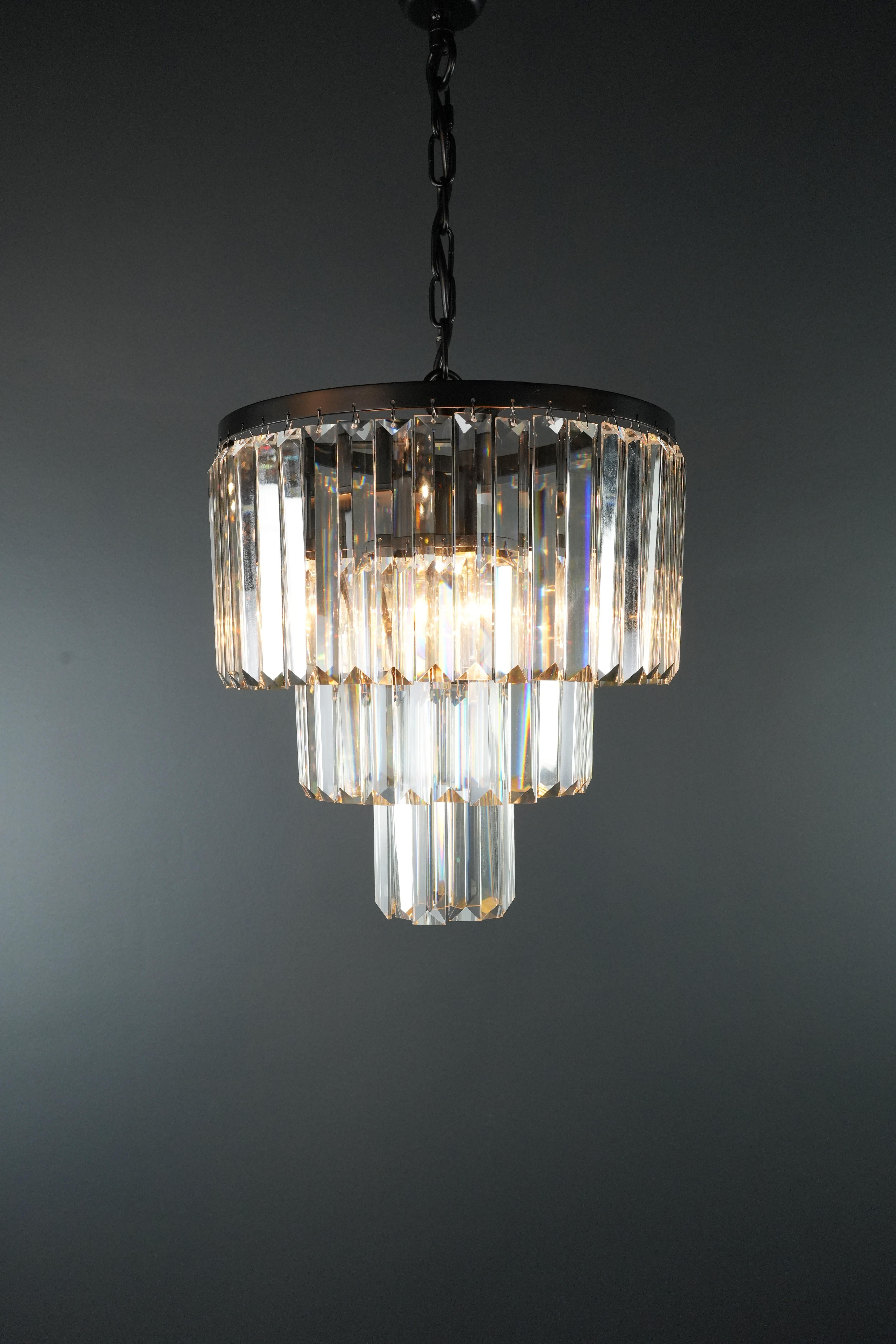 Immerse yourself in the fascinating world of postmodernism and experience pure elegance with our breathtaking black chandelier decorated with crystals. This work of art of lighting makes a statement in any room and gives your interior an