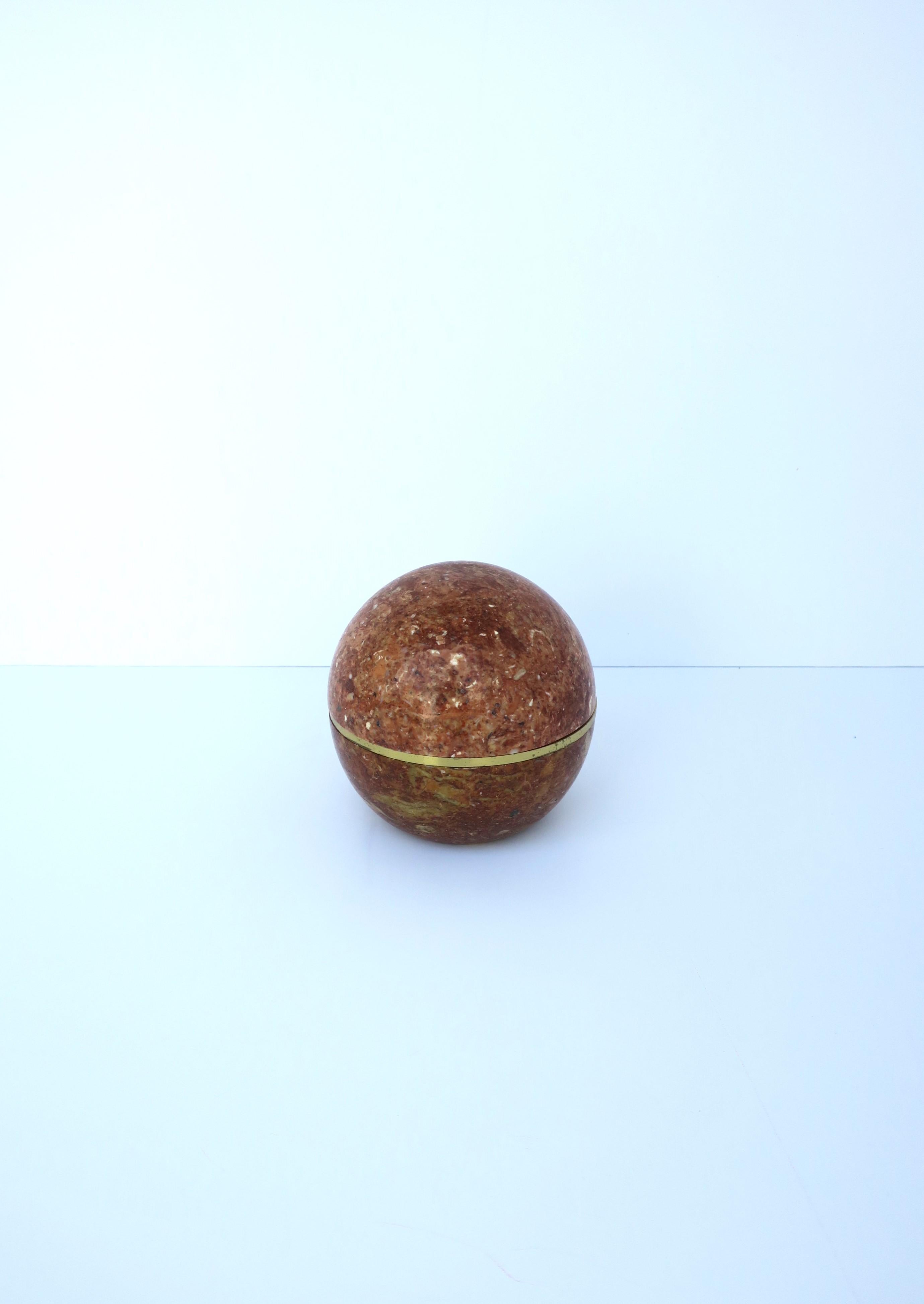 A chic Postmodern marble and brass sphere ball ashtray box, circa 1970s. Piece makes a great decorative object box as well as an ashtray (three indents around for cig's or other tobacco products.) Great as a standalone piece, ashtray or box to hold