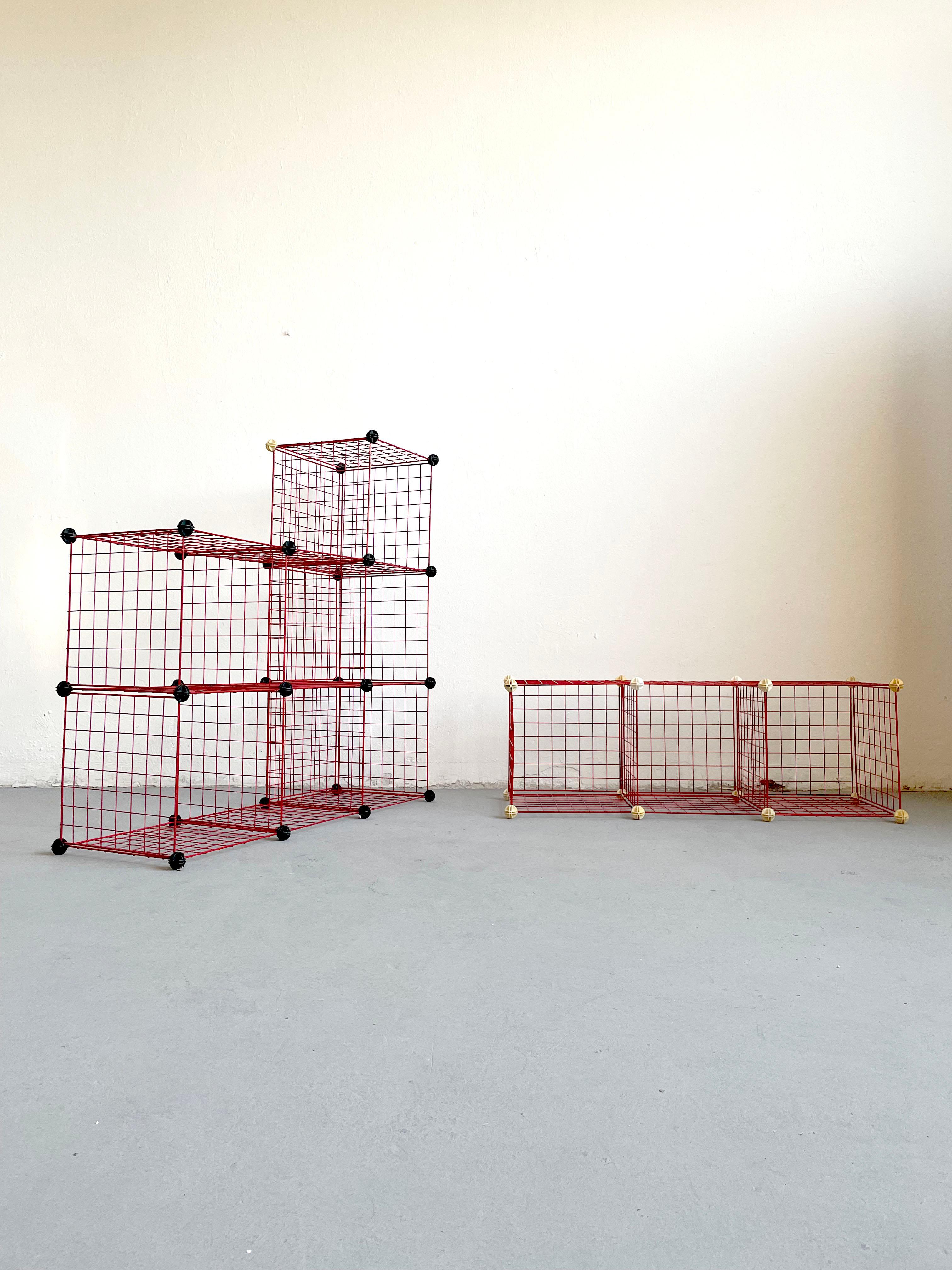 Vintage modular metal shelves from the 1980s.
This set consists of 36 red metal panels measuring 40 x 40 cm and 44 connecting plastic bowls in black and white color.

The set can be used in many combinations to make shelves, small tables, and
