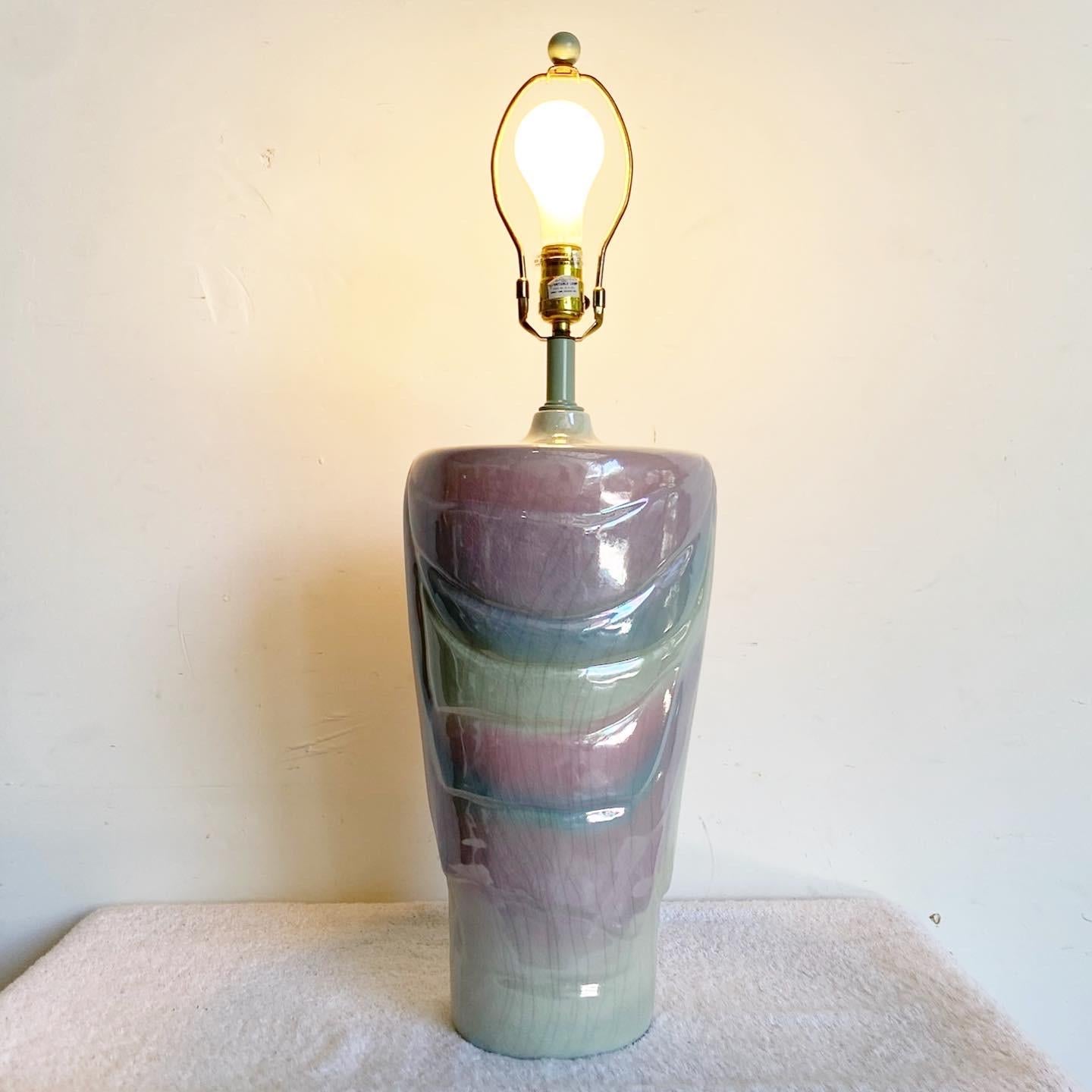 Elevate your space with the wonderful vintage postmodern ceramic table lamp. This captivating lamp features a glassed pastel blue, purple, and pink finish, adding a vibrant and mesmerizing touch to any room.

Wonderful vintage postmodern ceramic